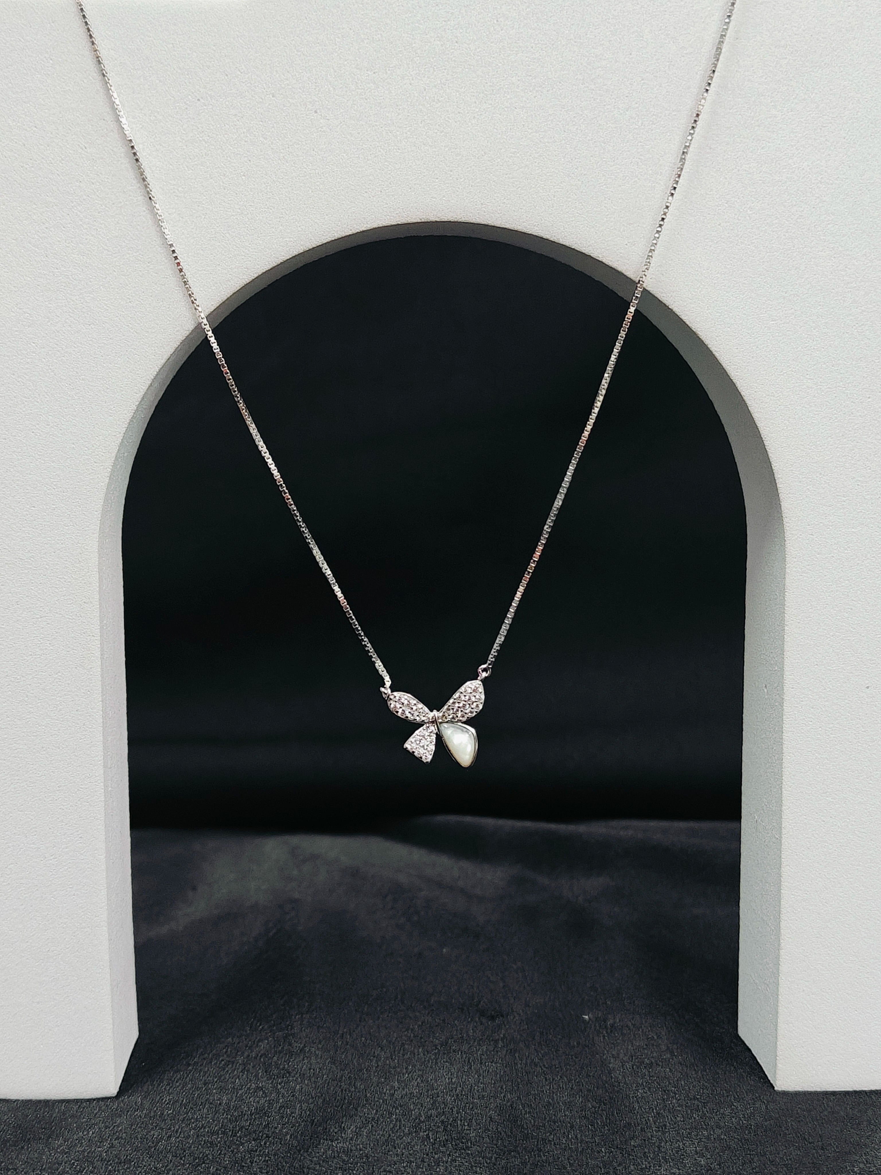Butterfly necklace on a gray background