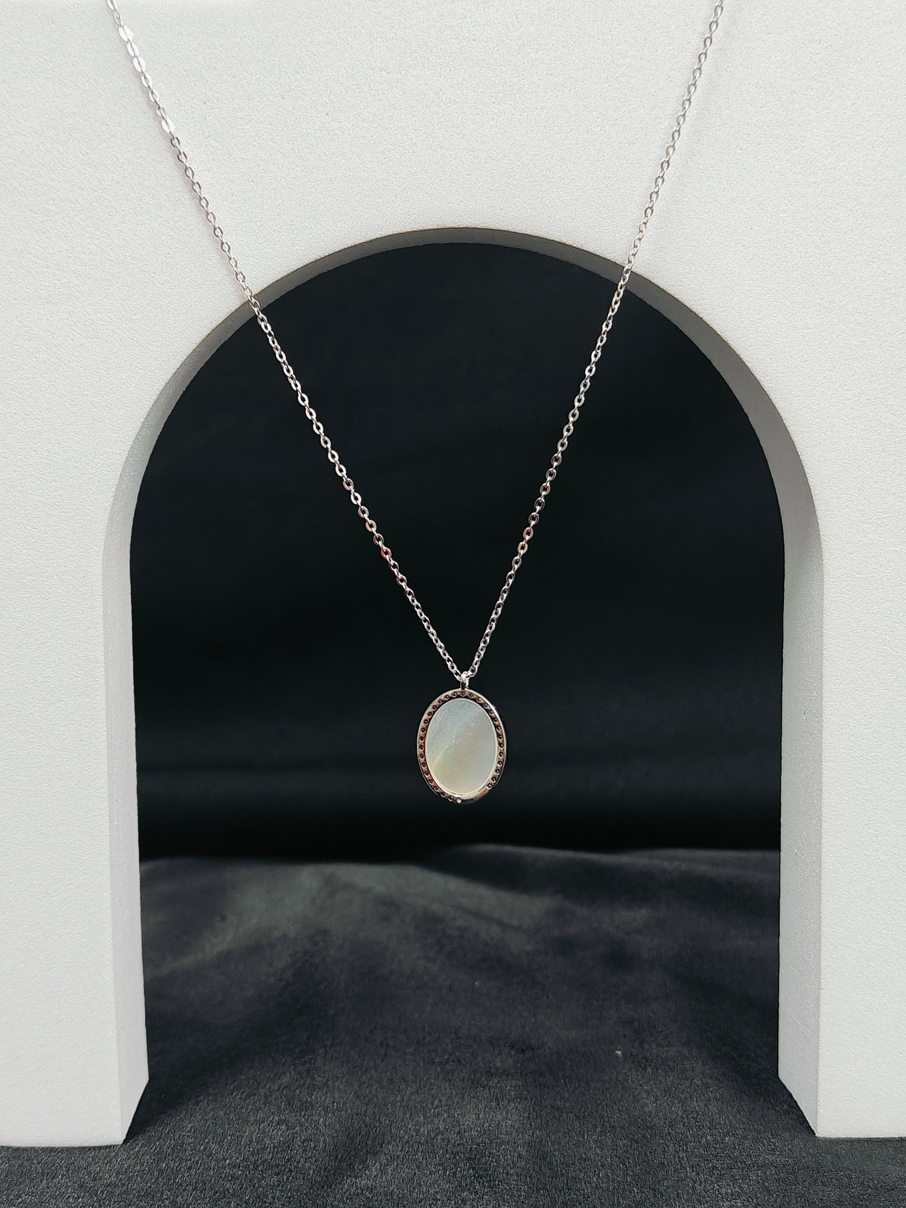 Necklace with a pendant hanging in front of a black background