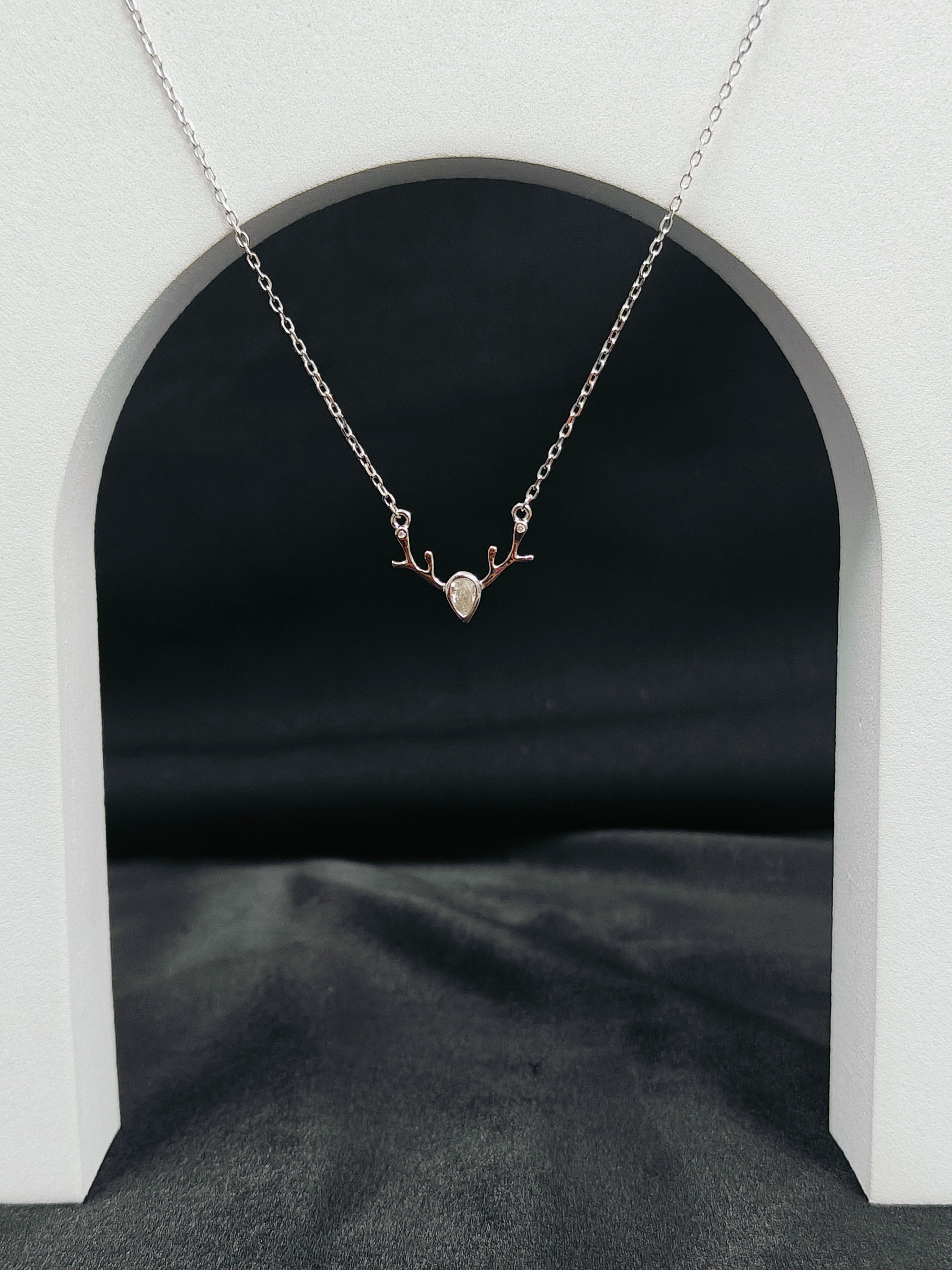 Necklace with a heart-shaped pendant on a white arch background