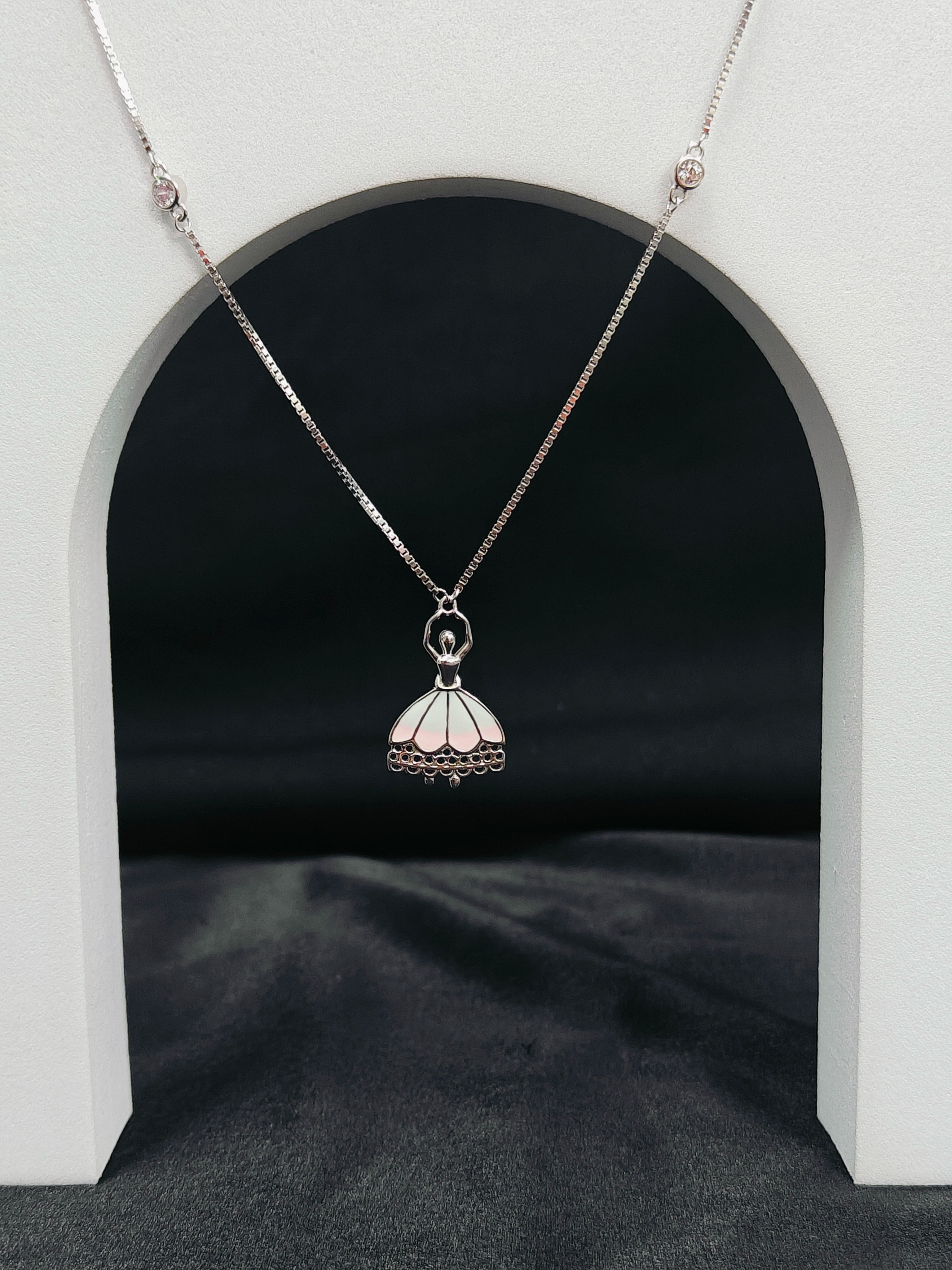 Silver necklace with a pendant on a dark background