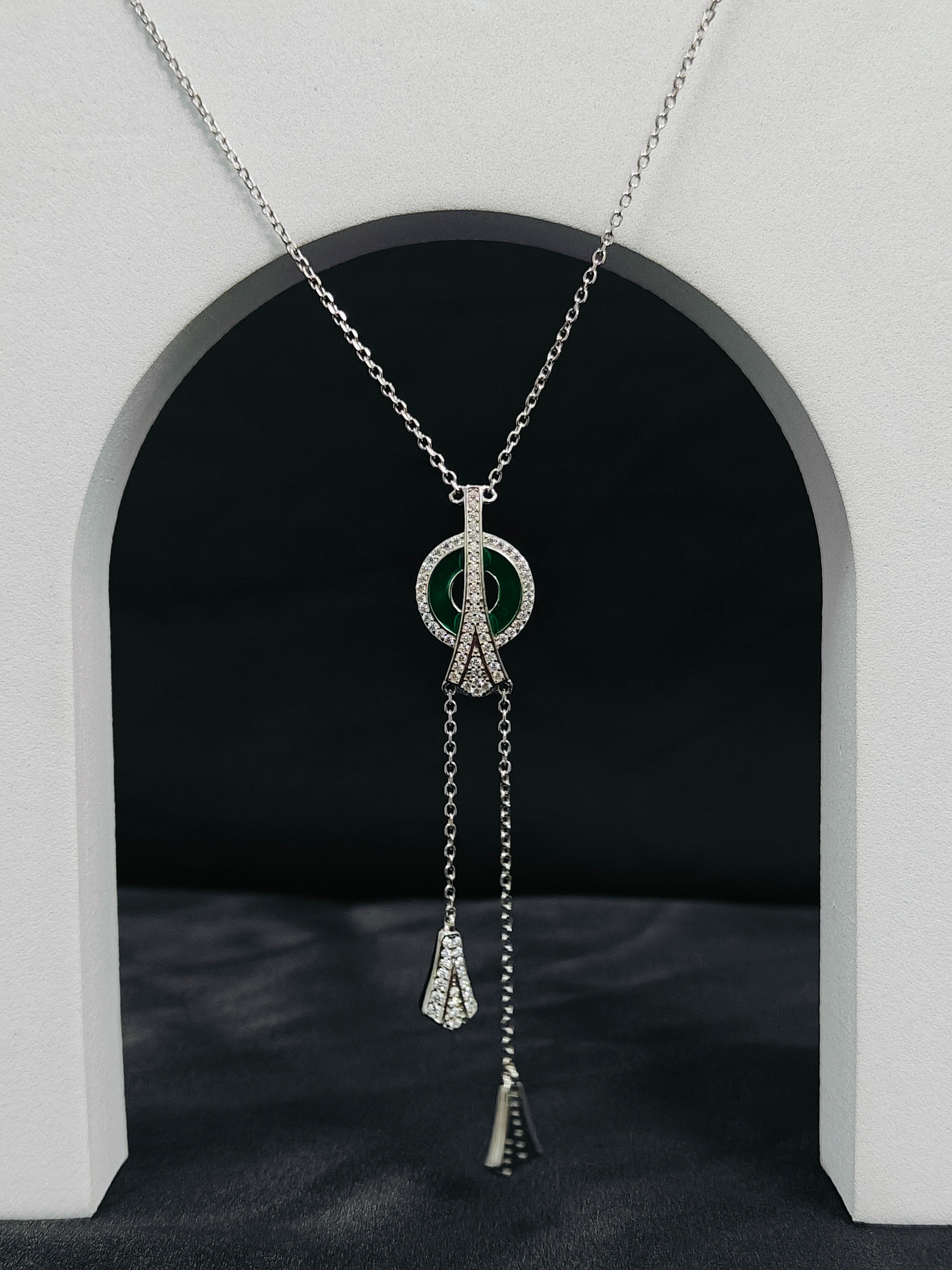 Silver necklace with a peace symbol pendant on a gray background