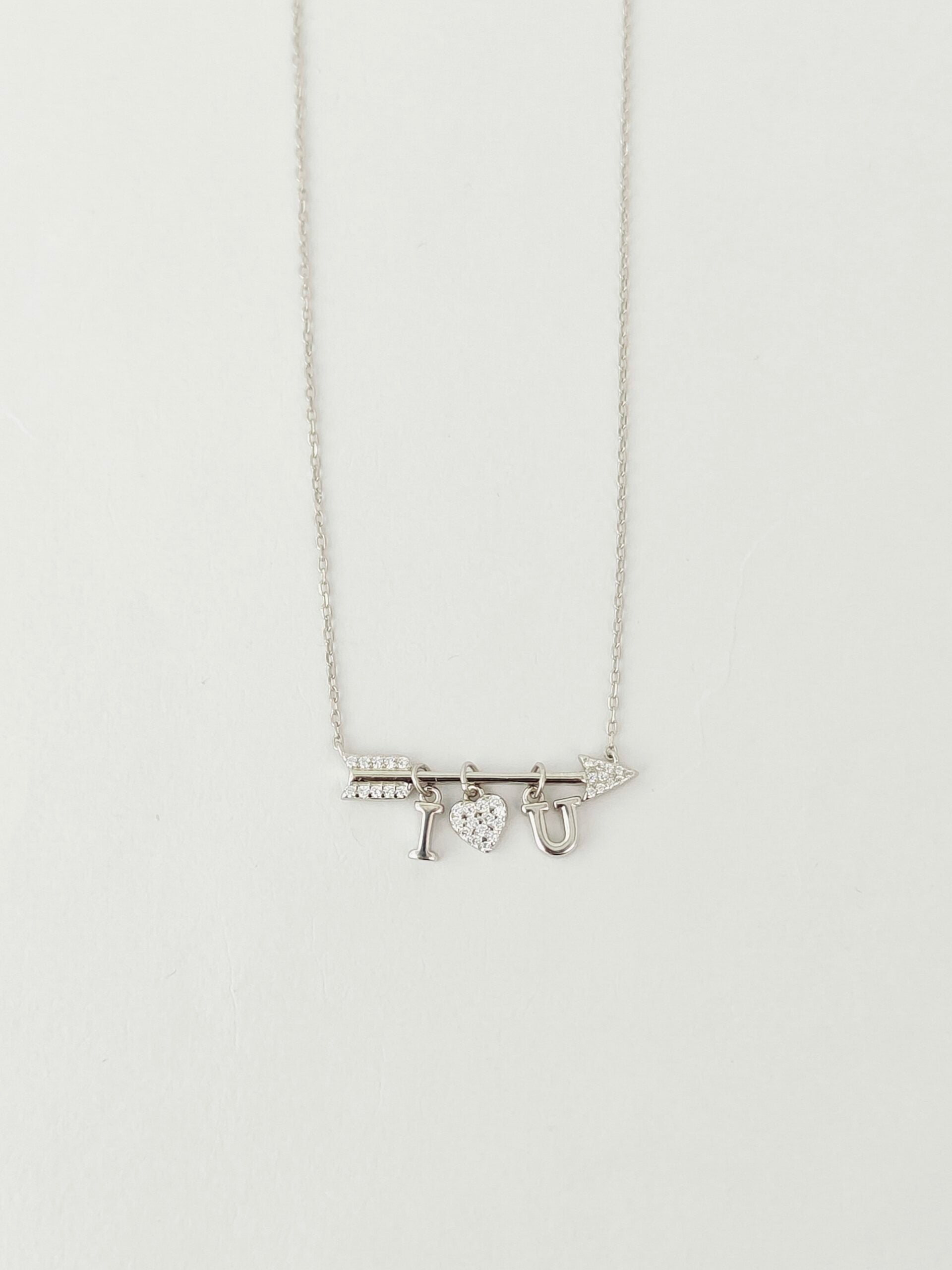 Silver necklace with a pendant on a light gray background