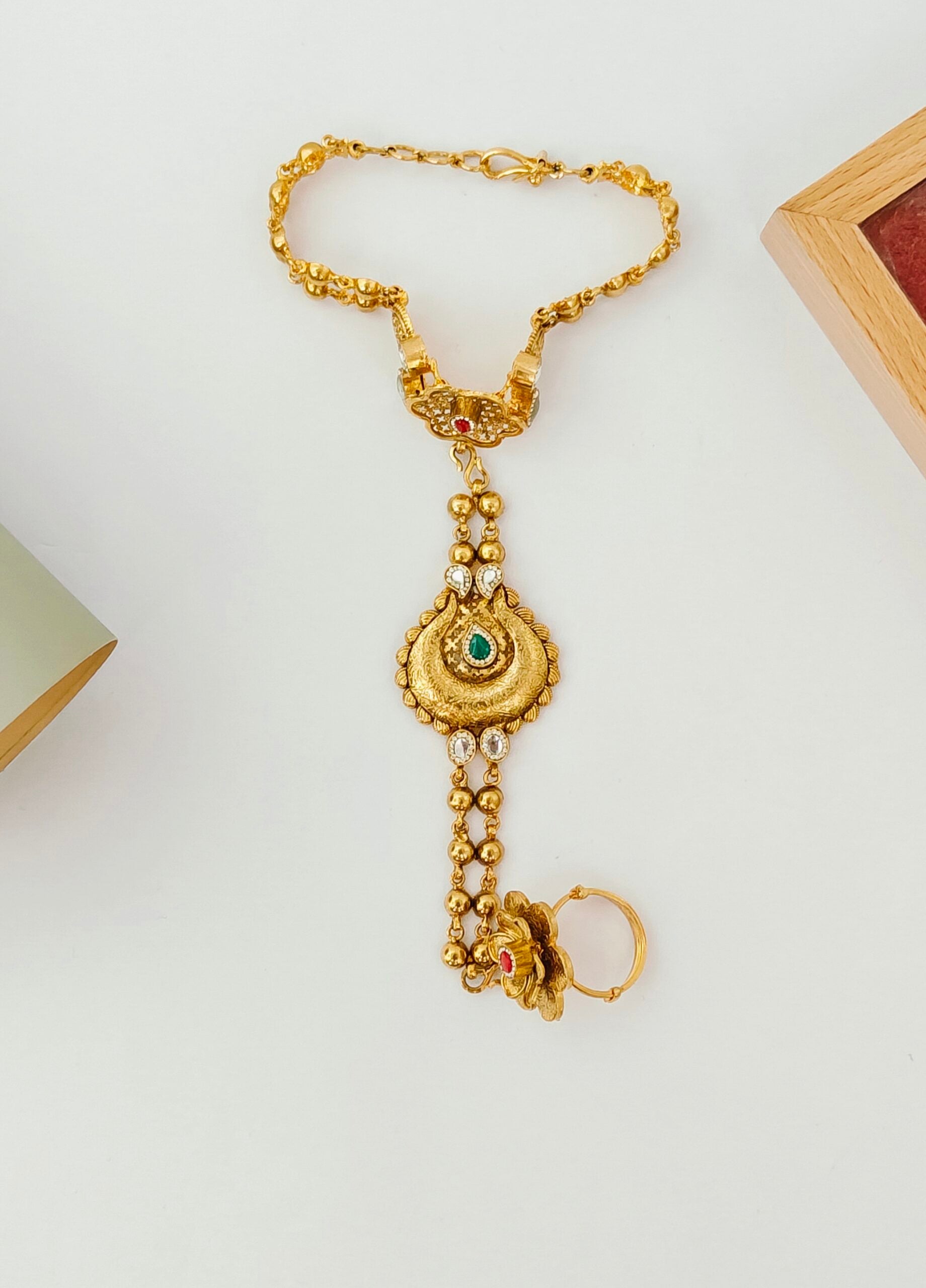 Gold necklace with pendant on a white background