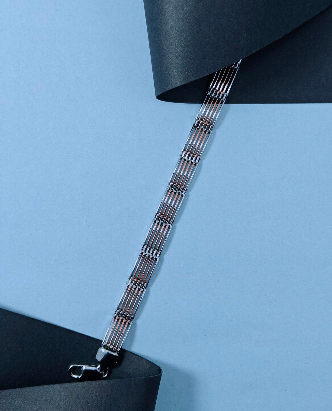 Silver bracelet on a blue background