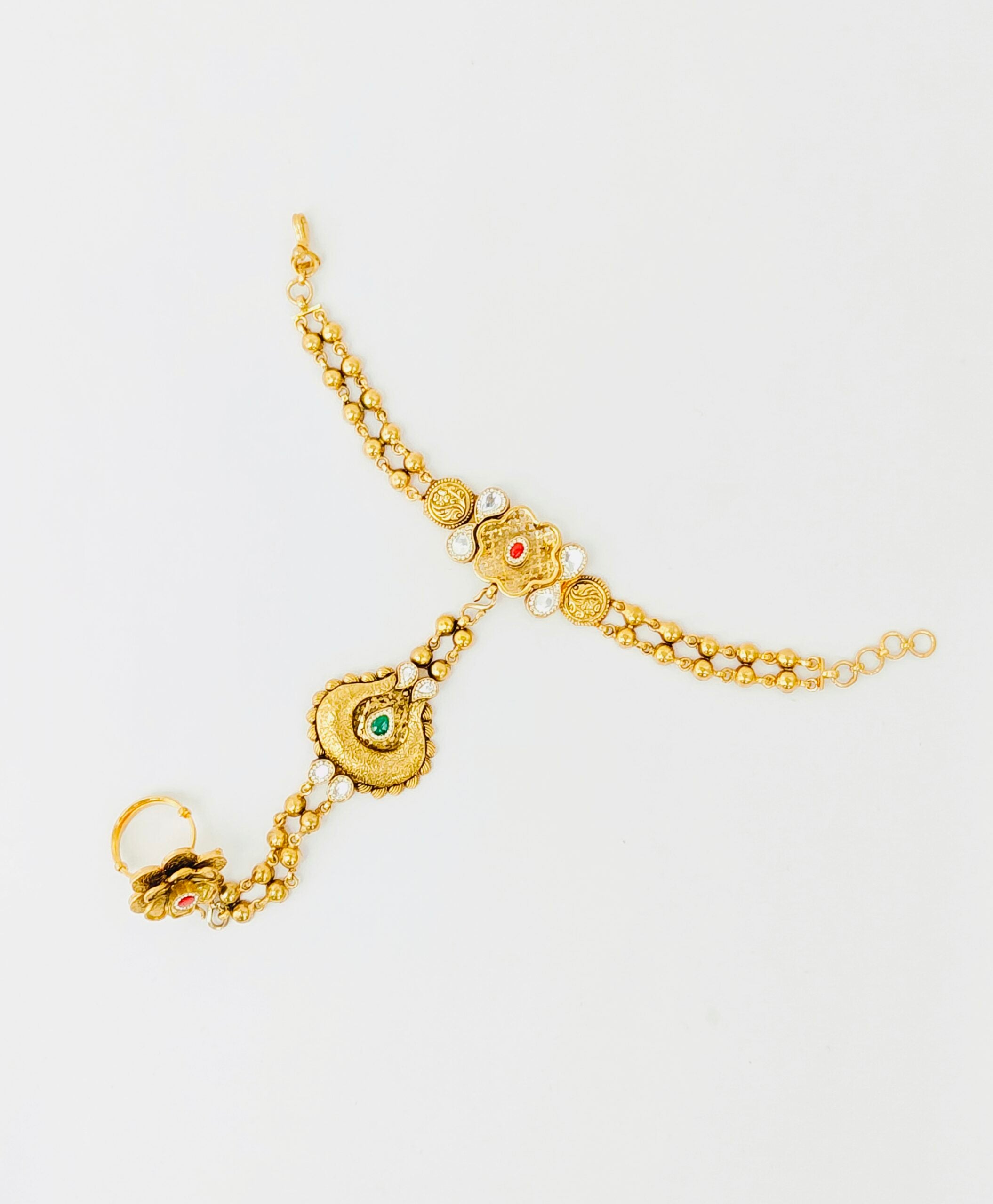 Gold bracelet with intricate designs on a white background