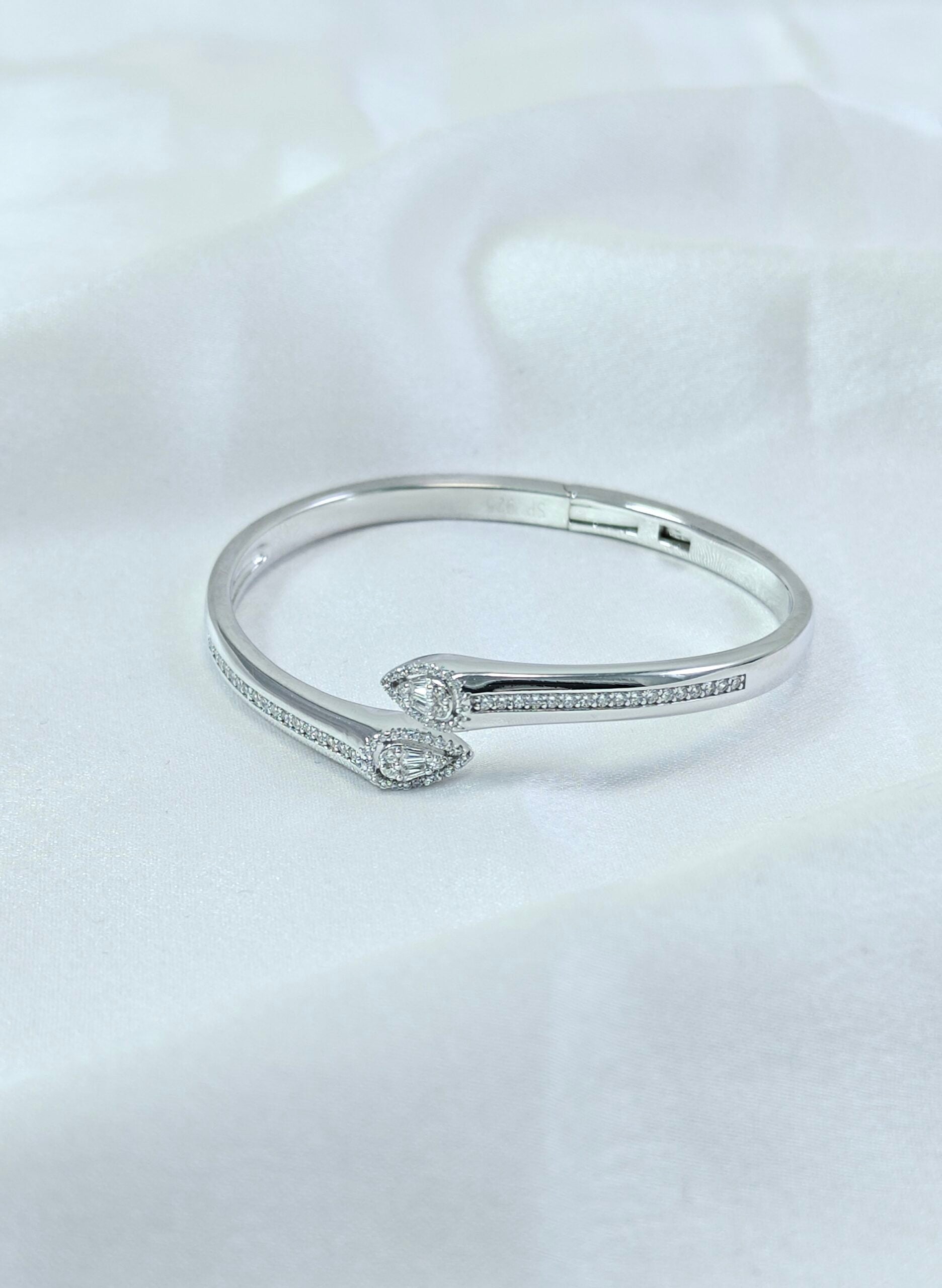 Silver bracelet with small diamonds on a white background