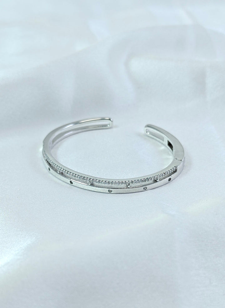 Silver bracelet with small stones on a white background
