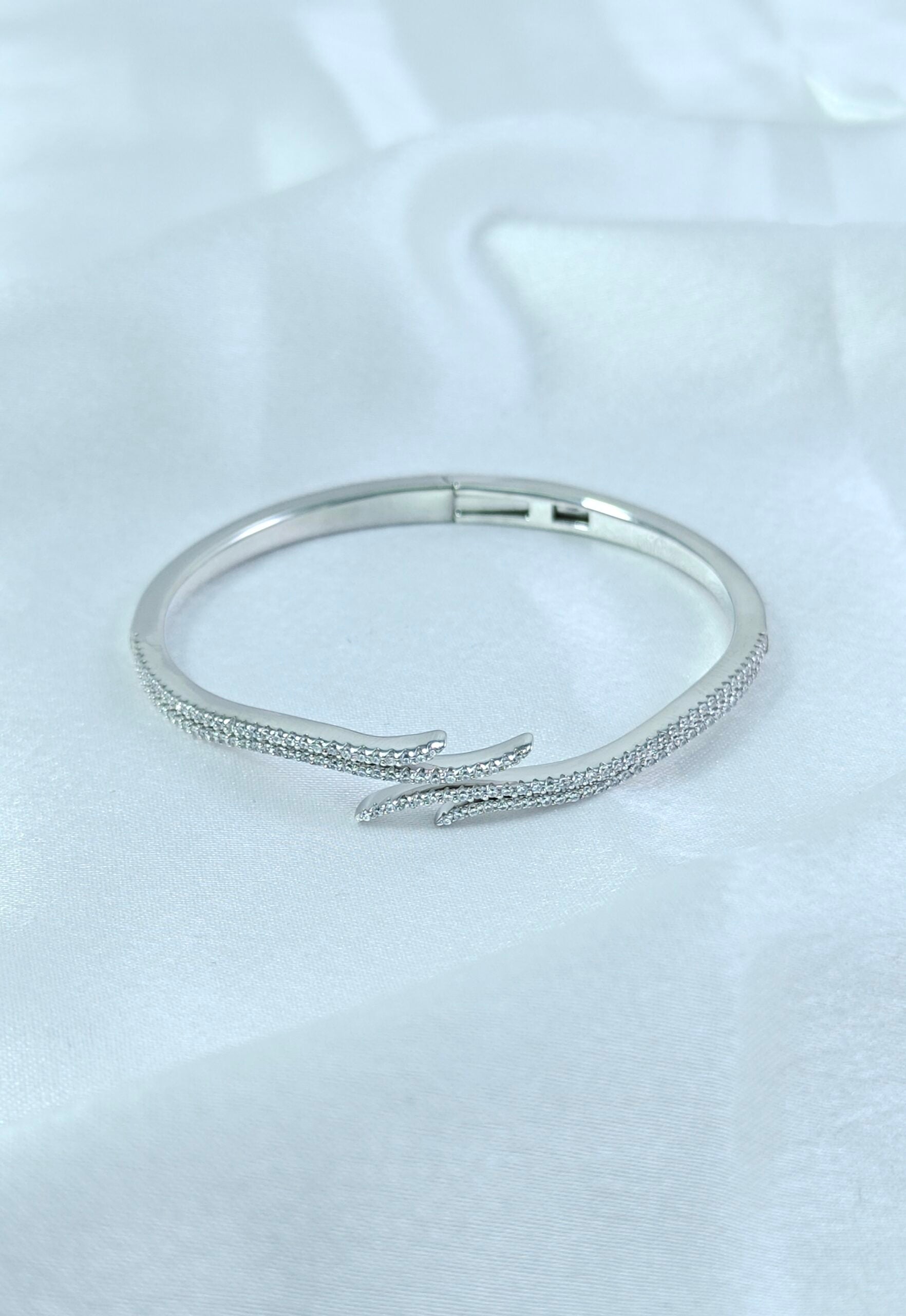 Silver bracelet on a light gray background