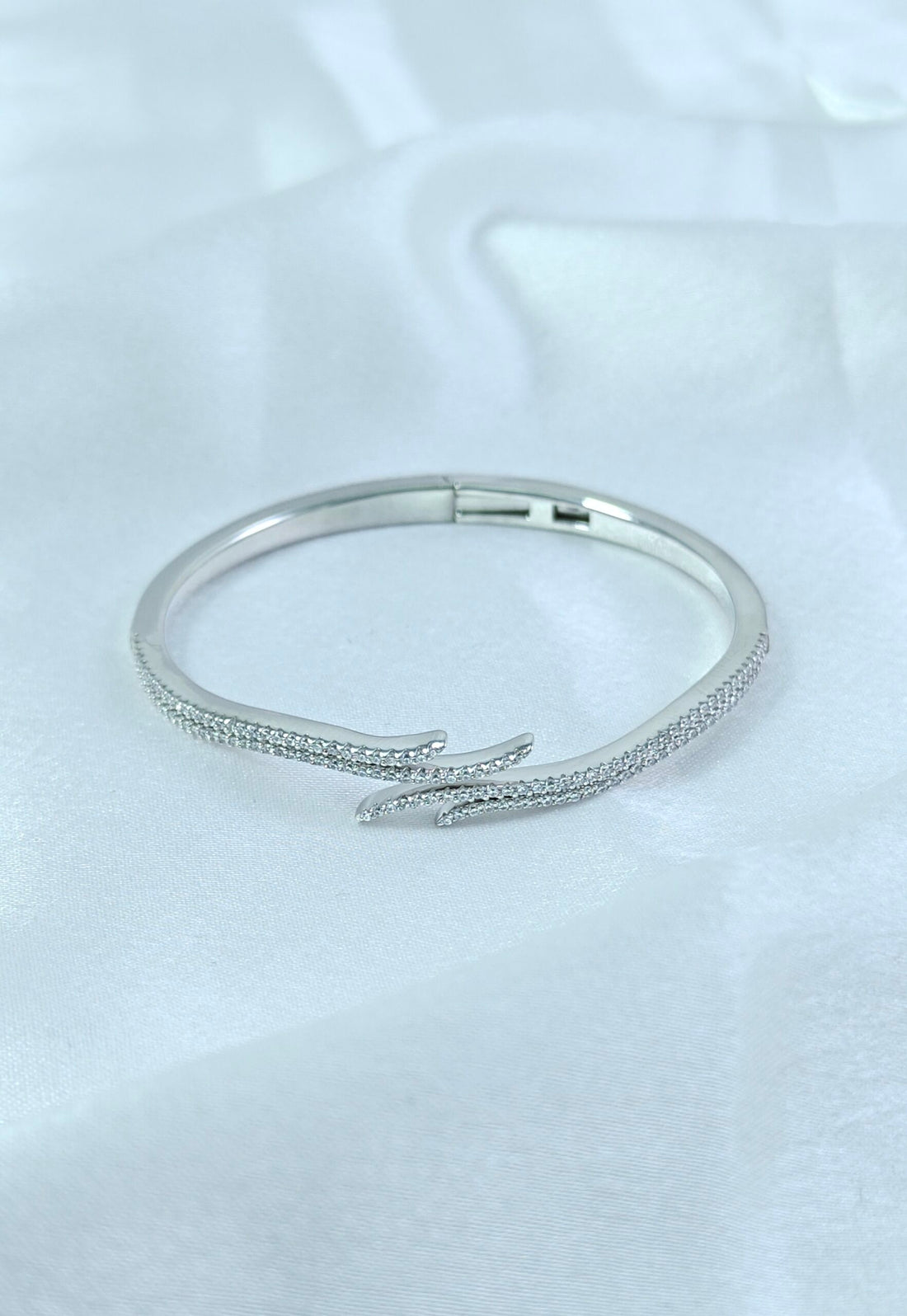 Silver bracelet on a light gray background
