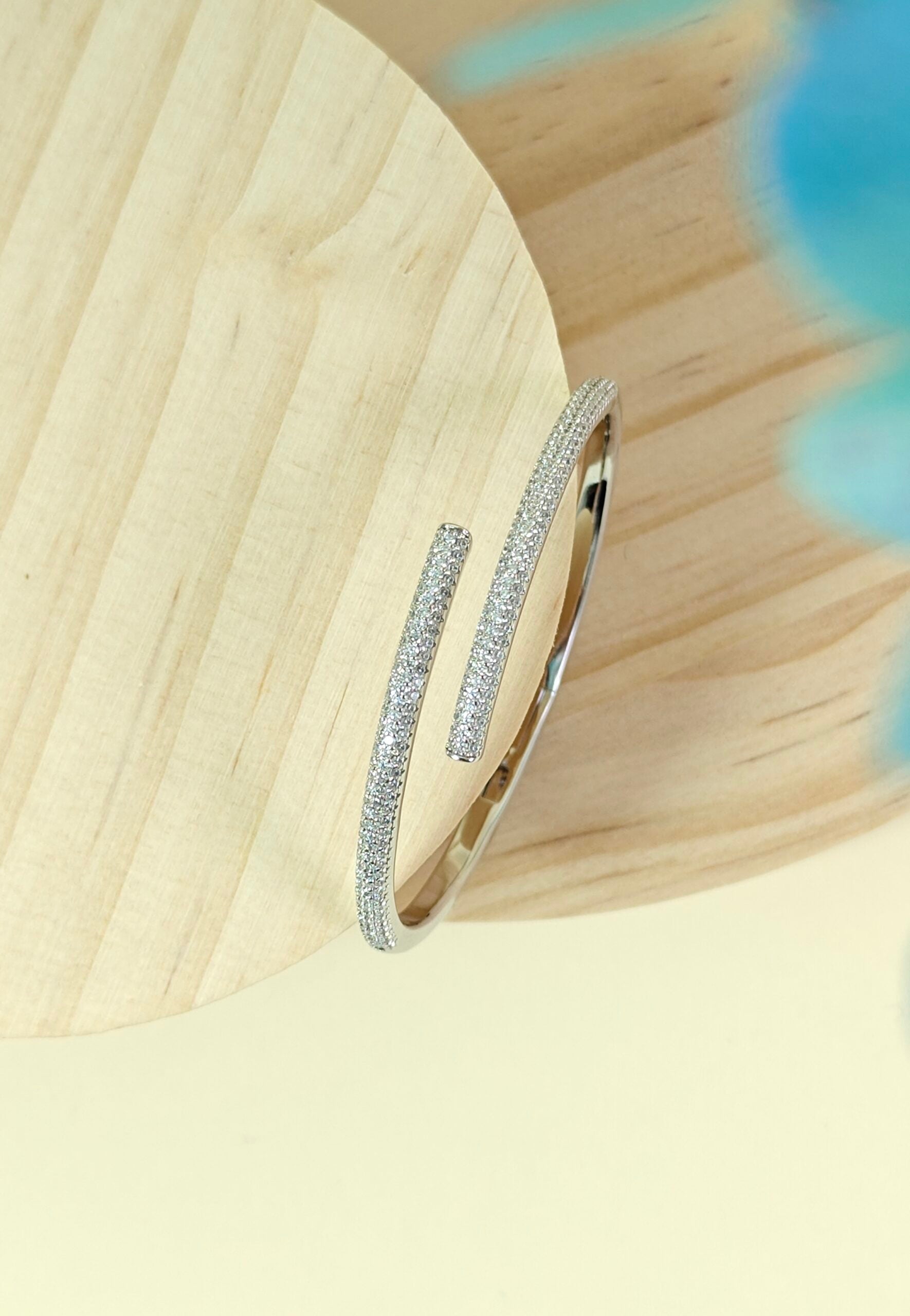 Silver hoop earrings on a wooden surface