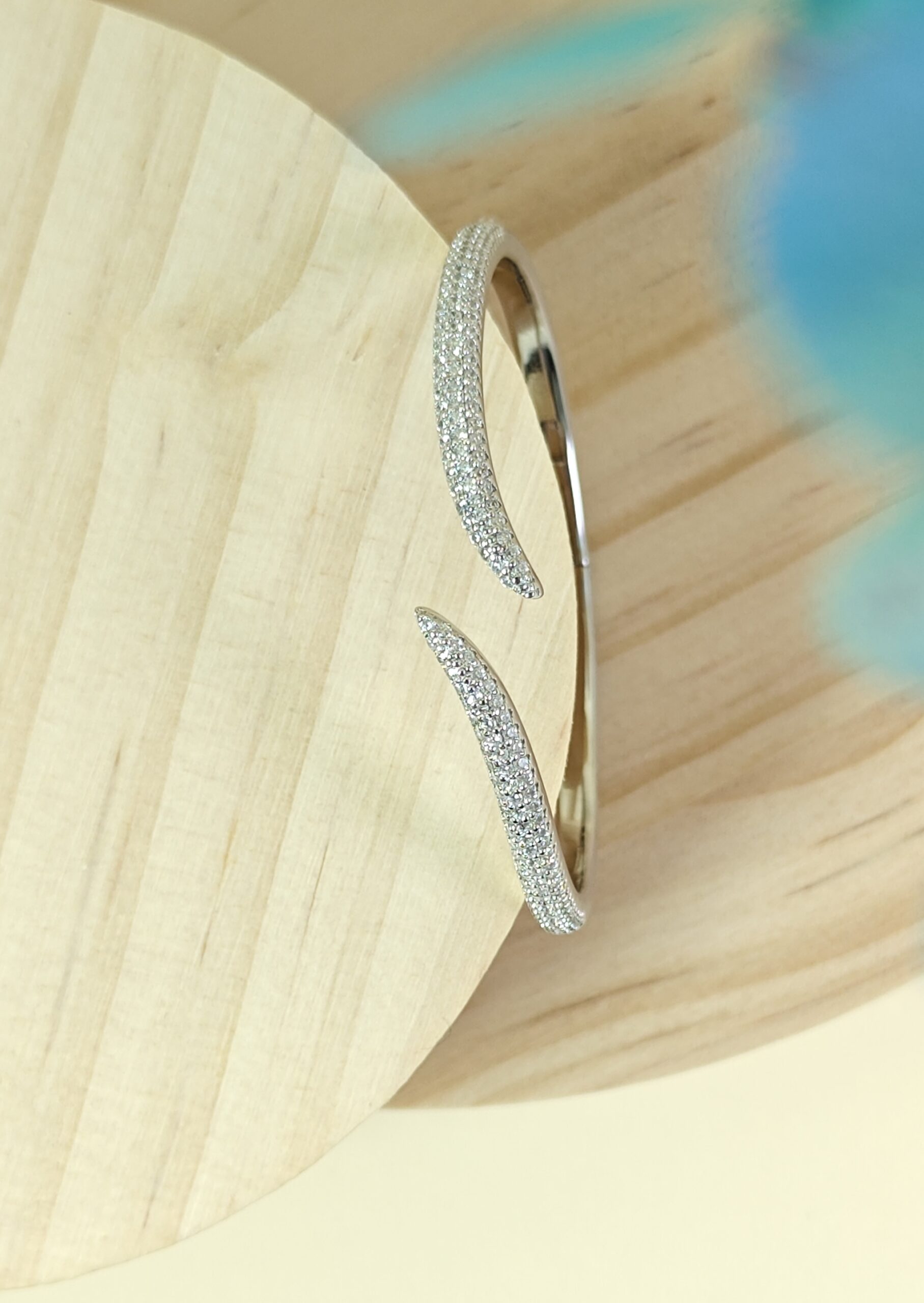Silver hoop earrings on a light wooden surface
