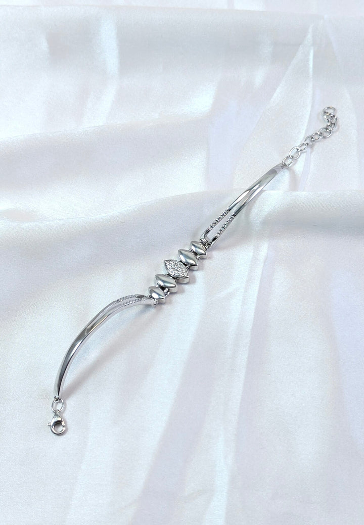 Silver bracelet with stones on a white satin background