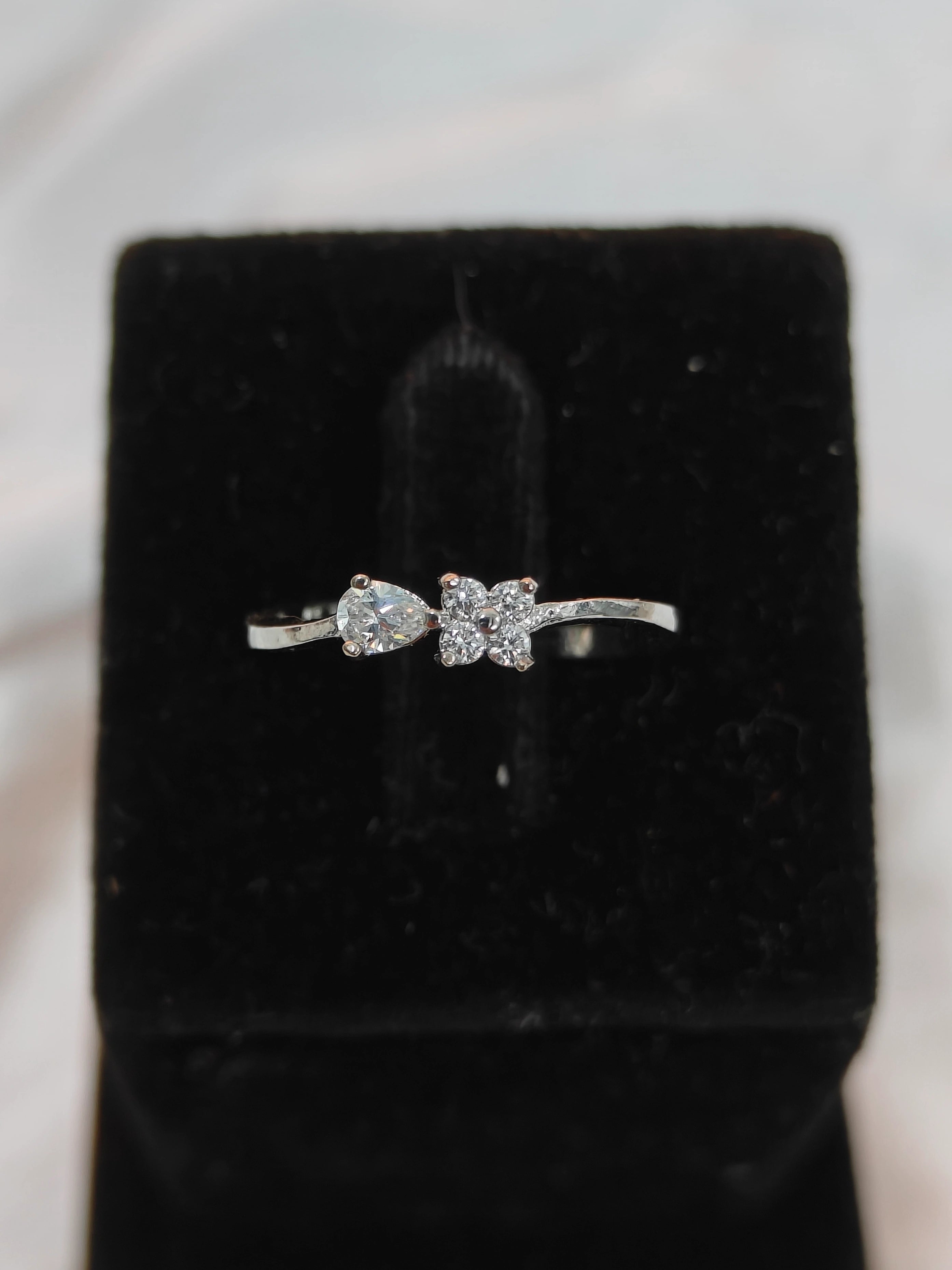 Diamond ring on a black velvet cushion with a blurred background