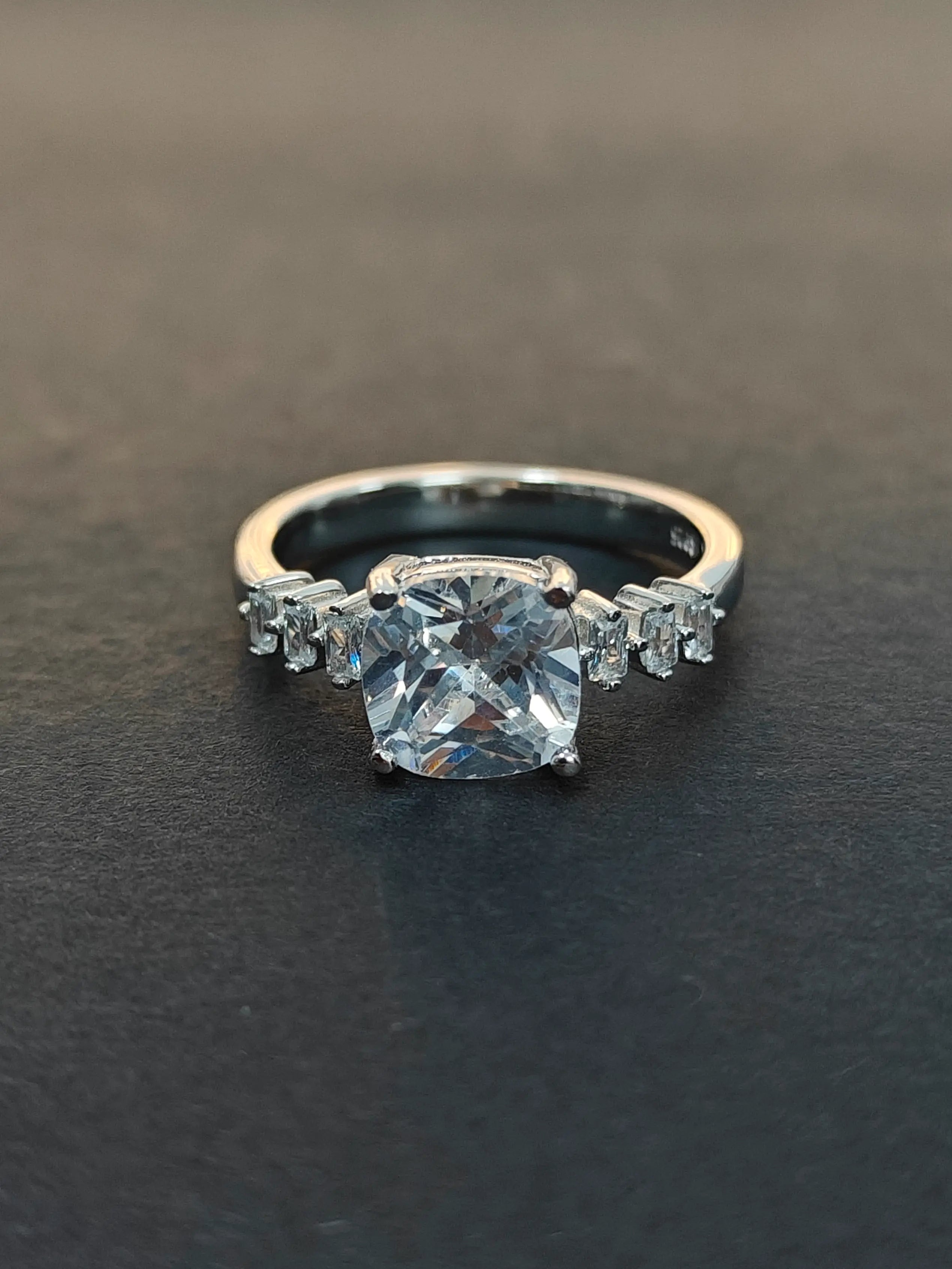 Diamond ring on a dark surface