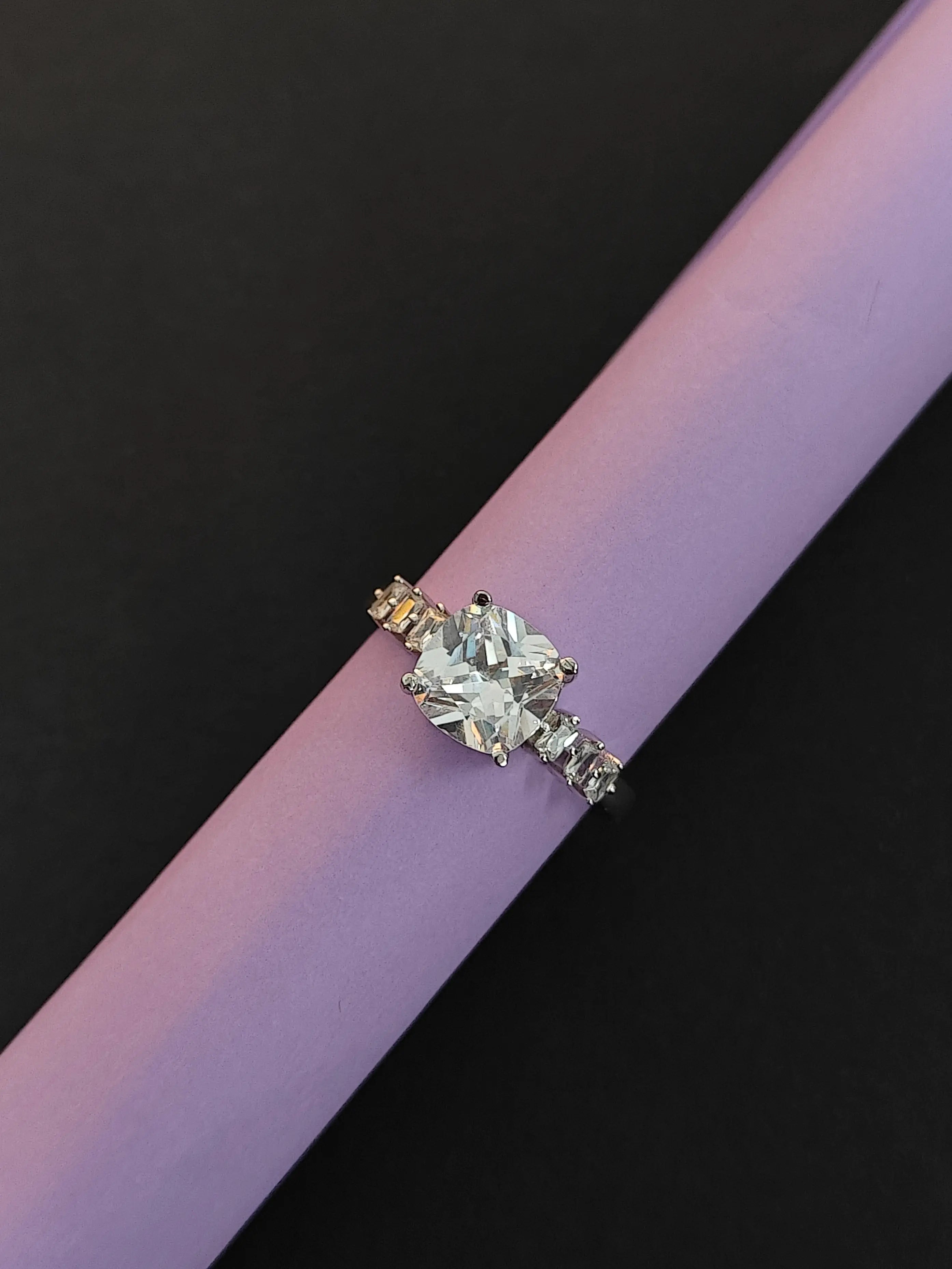 Diamond ring on a pink and black background