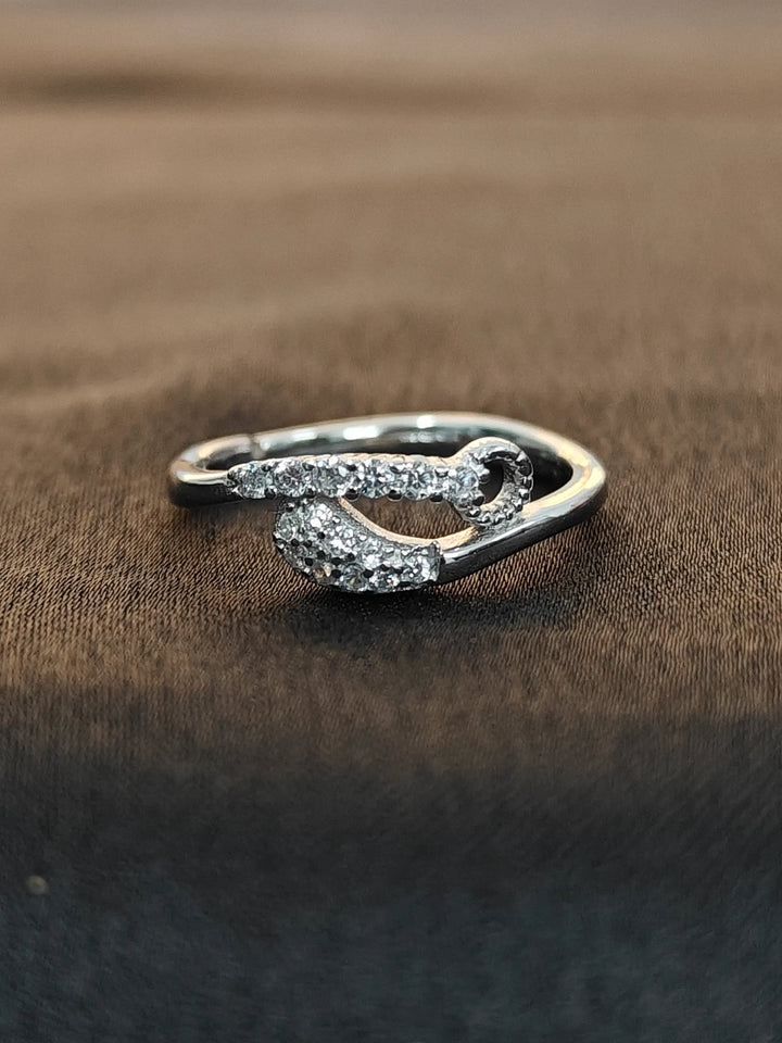 Silver ring with gemstones on a brown fabric background