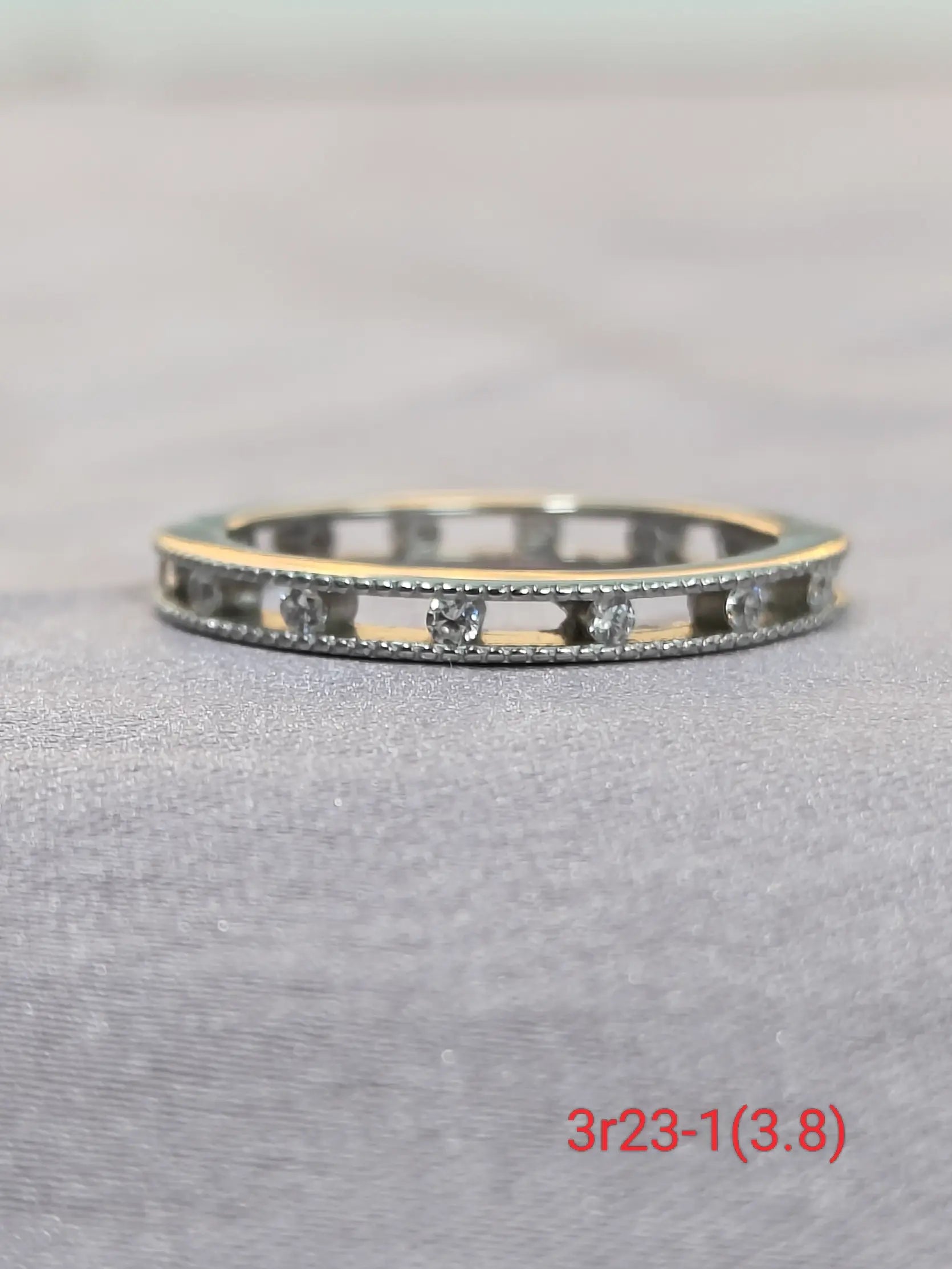 Silver bracelet with small stones on a gray surface