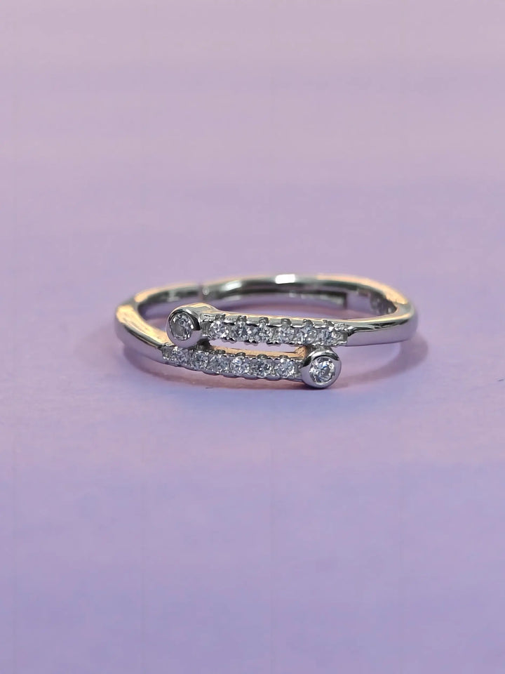 Gold and silver ring with diamonds on a purple background