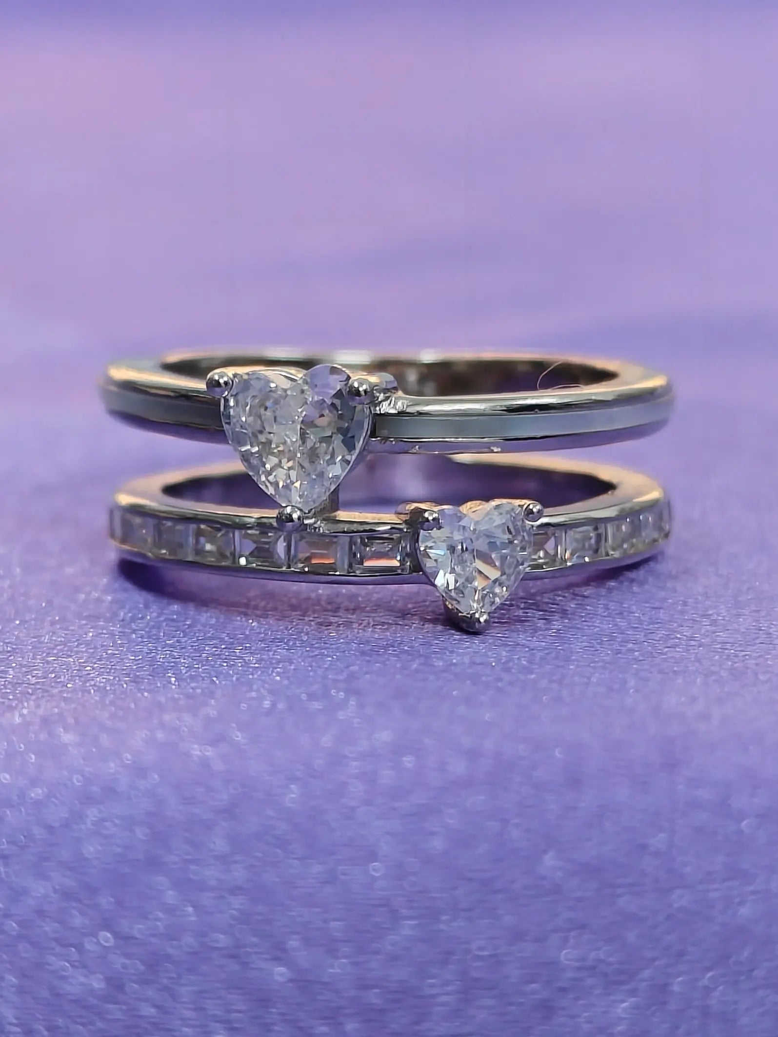 Two diamond rings on a purple background
