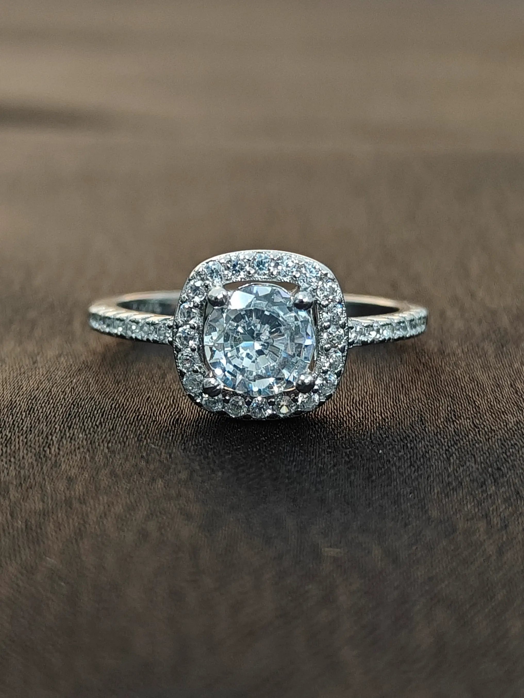 Diamond ring with a brown background