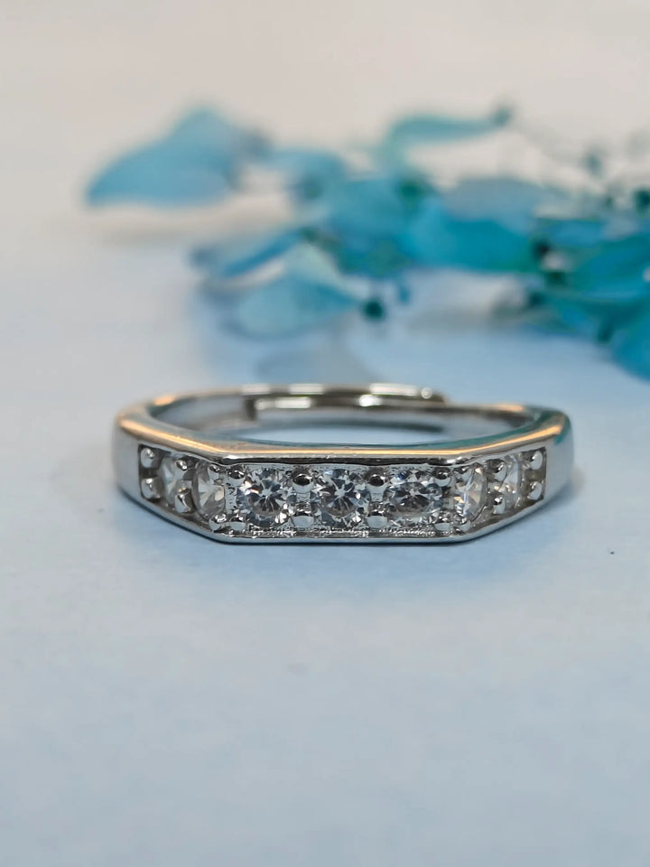 Silver ring with diamonds on a light blue background