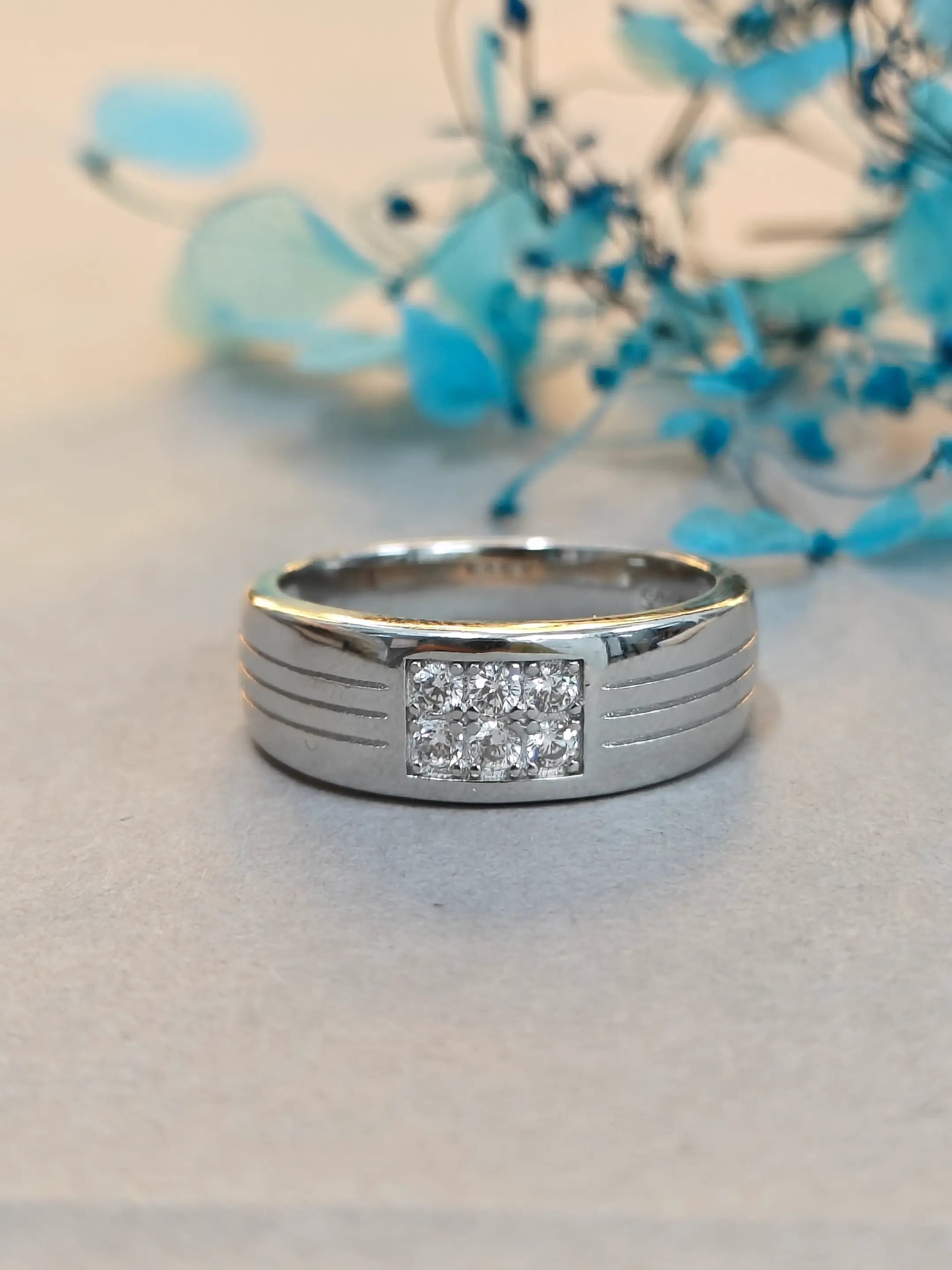 Silver ring with a diamond on a light background