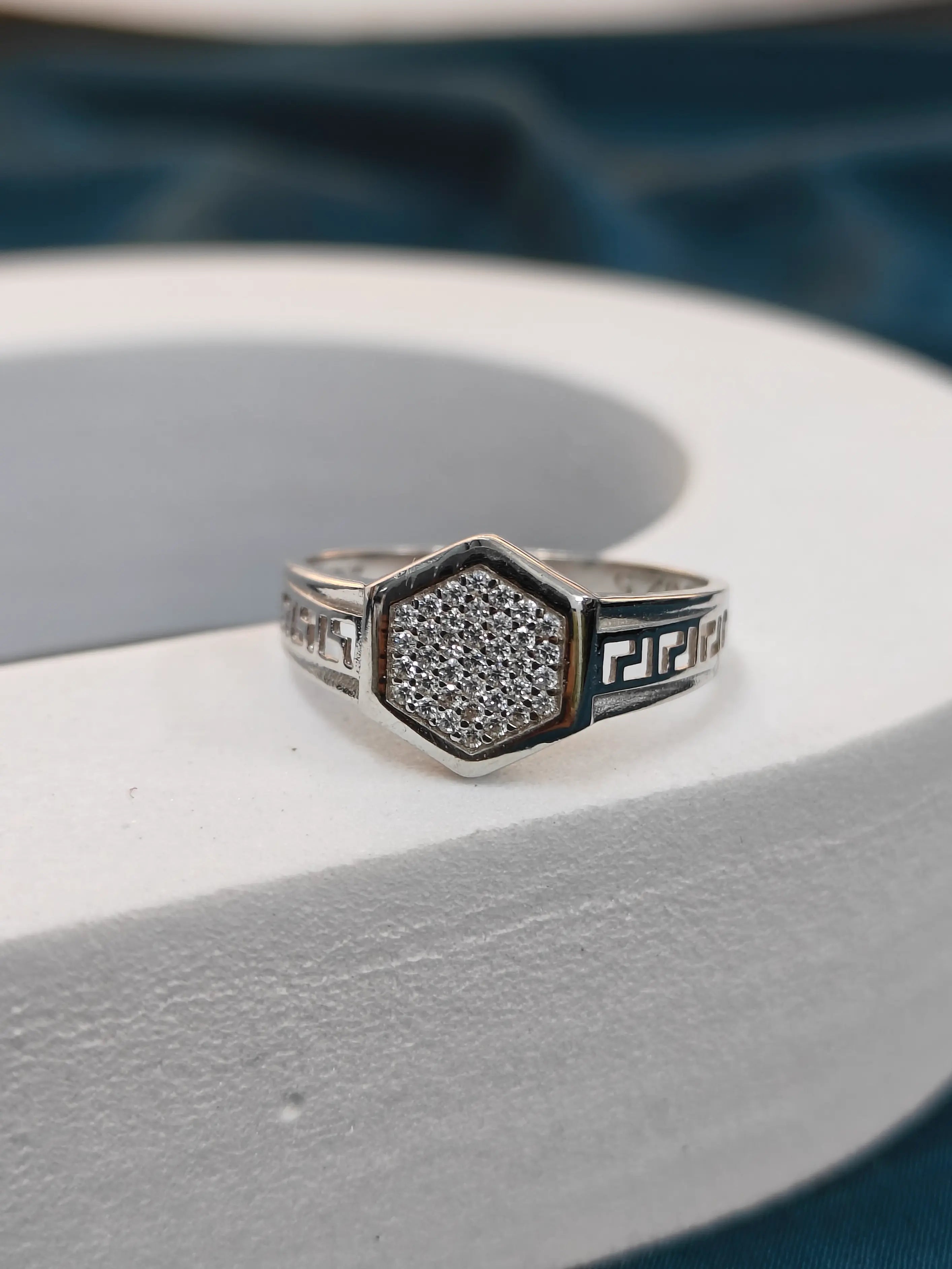 Silver ring with gemstone on a white surface