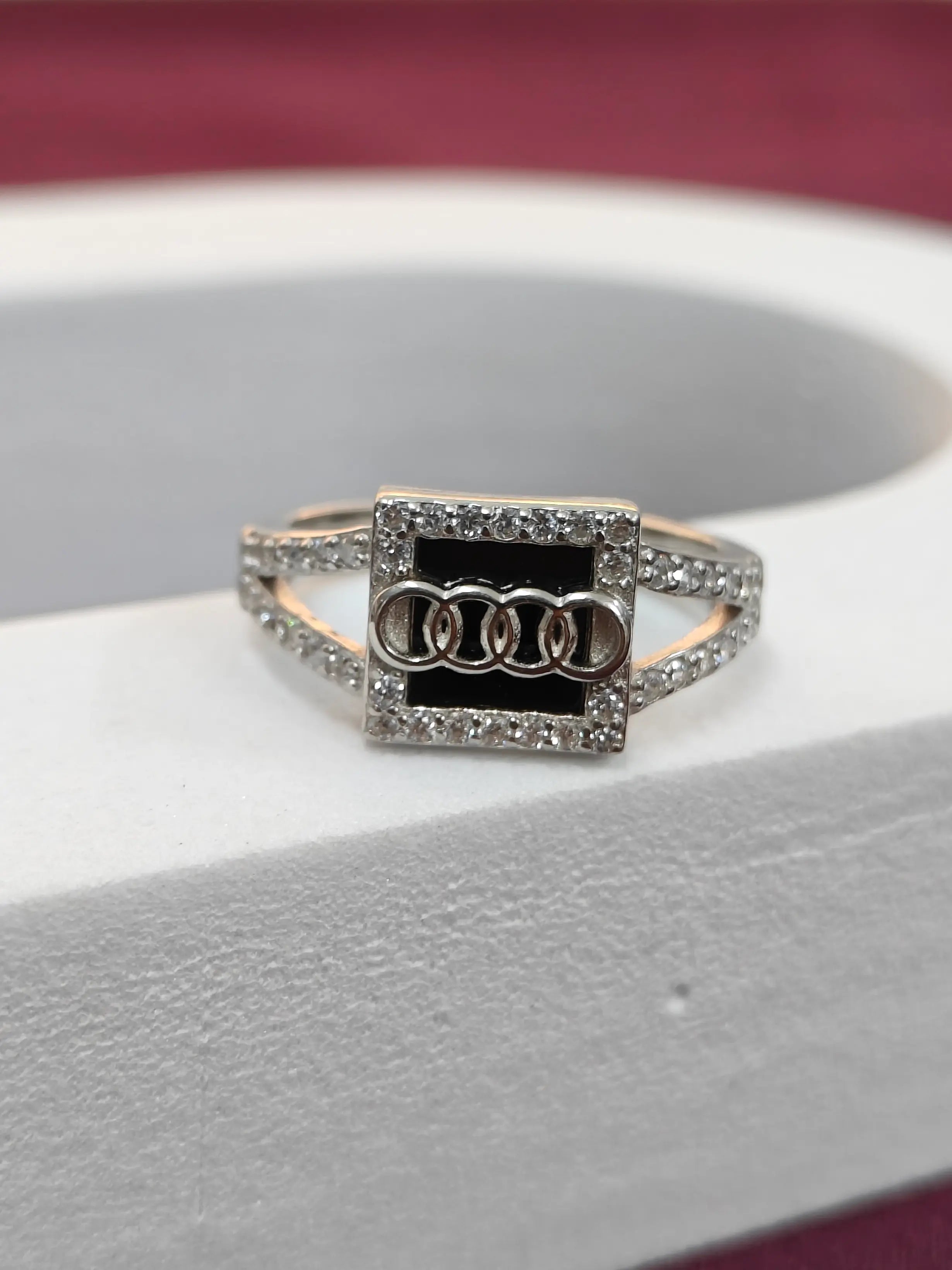 Ring with Audi logo on a car seat