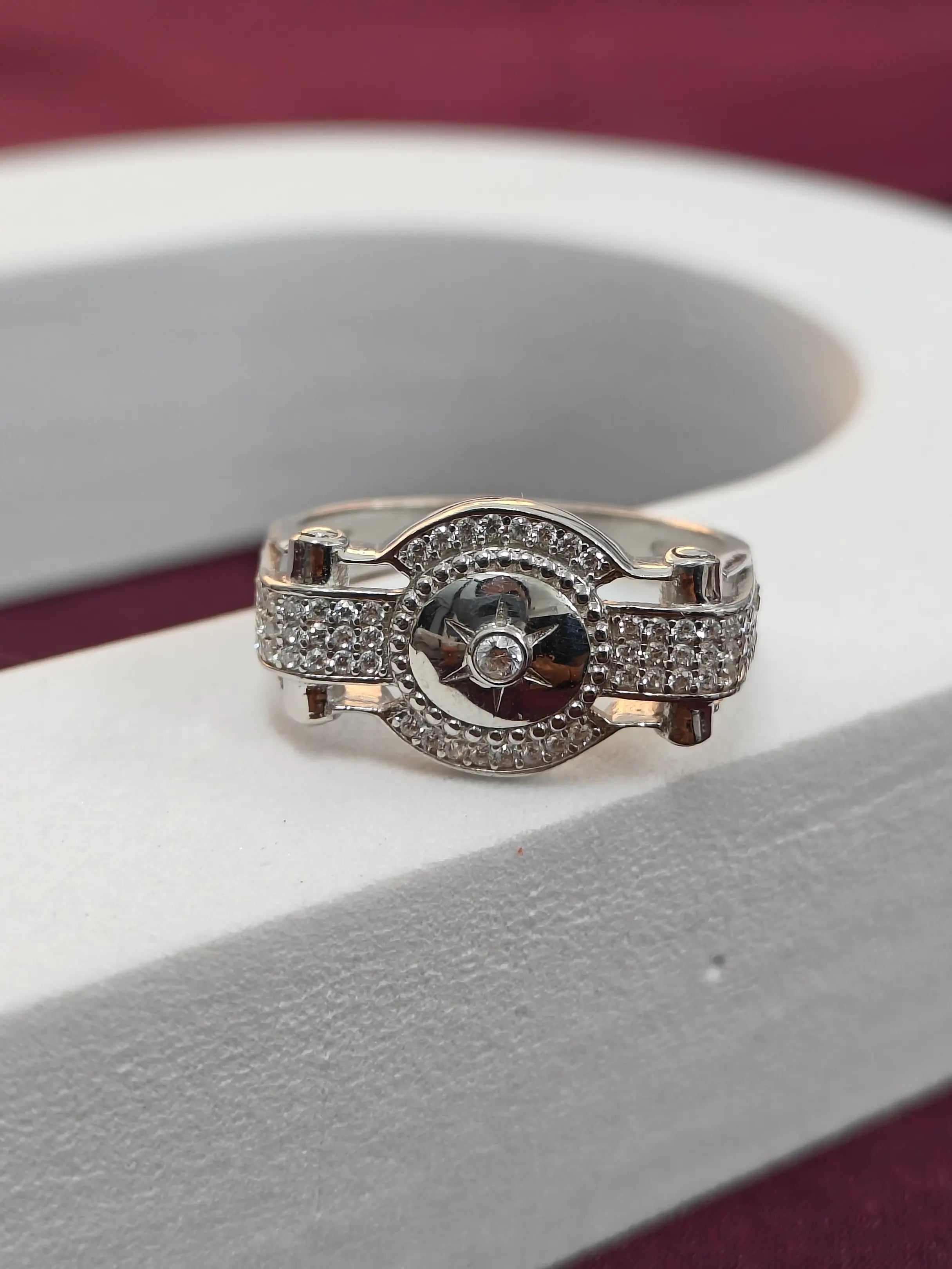 Silver ring with gemstone on a white surface