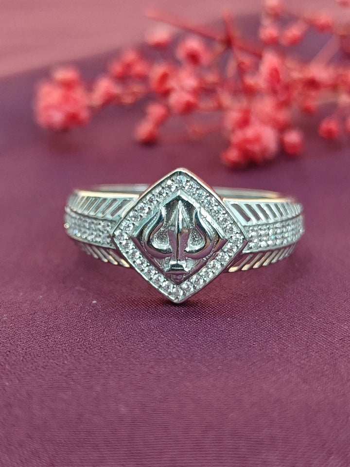 Silver ring with a diamond-shaped design on a purple background