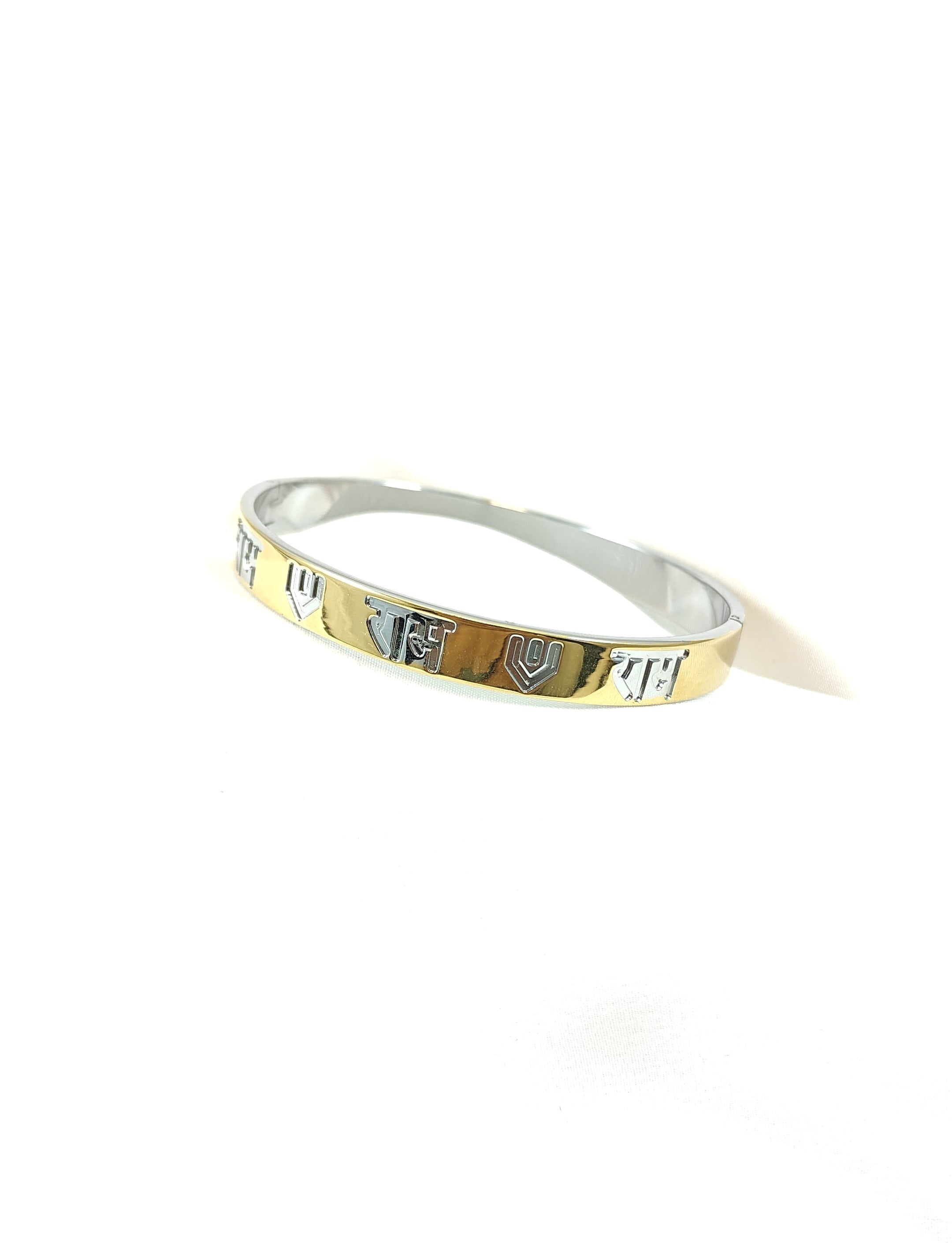 Gold and silver bracelet on a white background