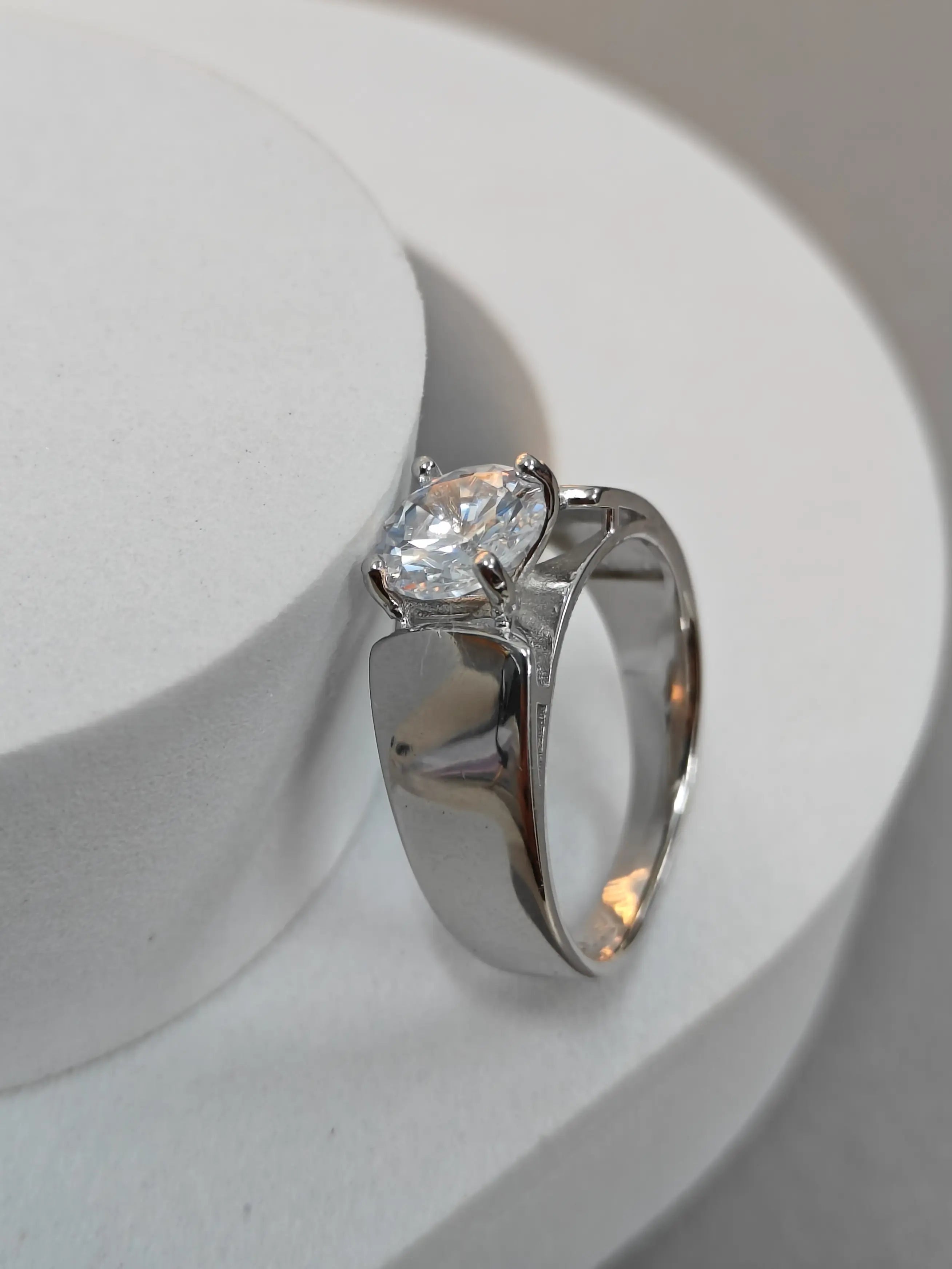 Silver ring with a diamond on a white background