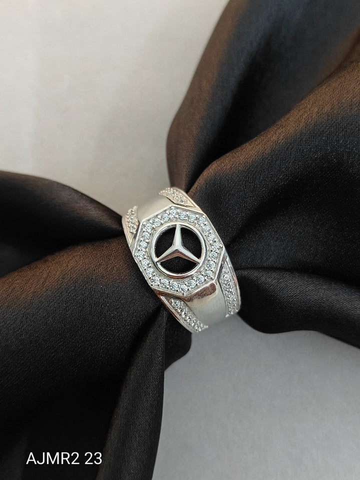Silver ring with Mercedes-Benz logo on a black fabric background