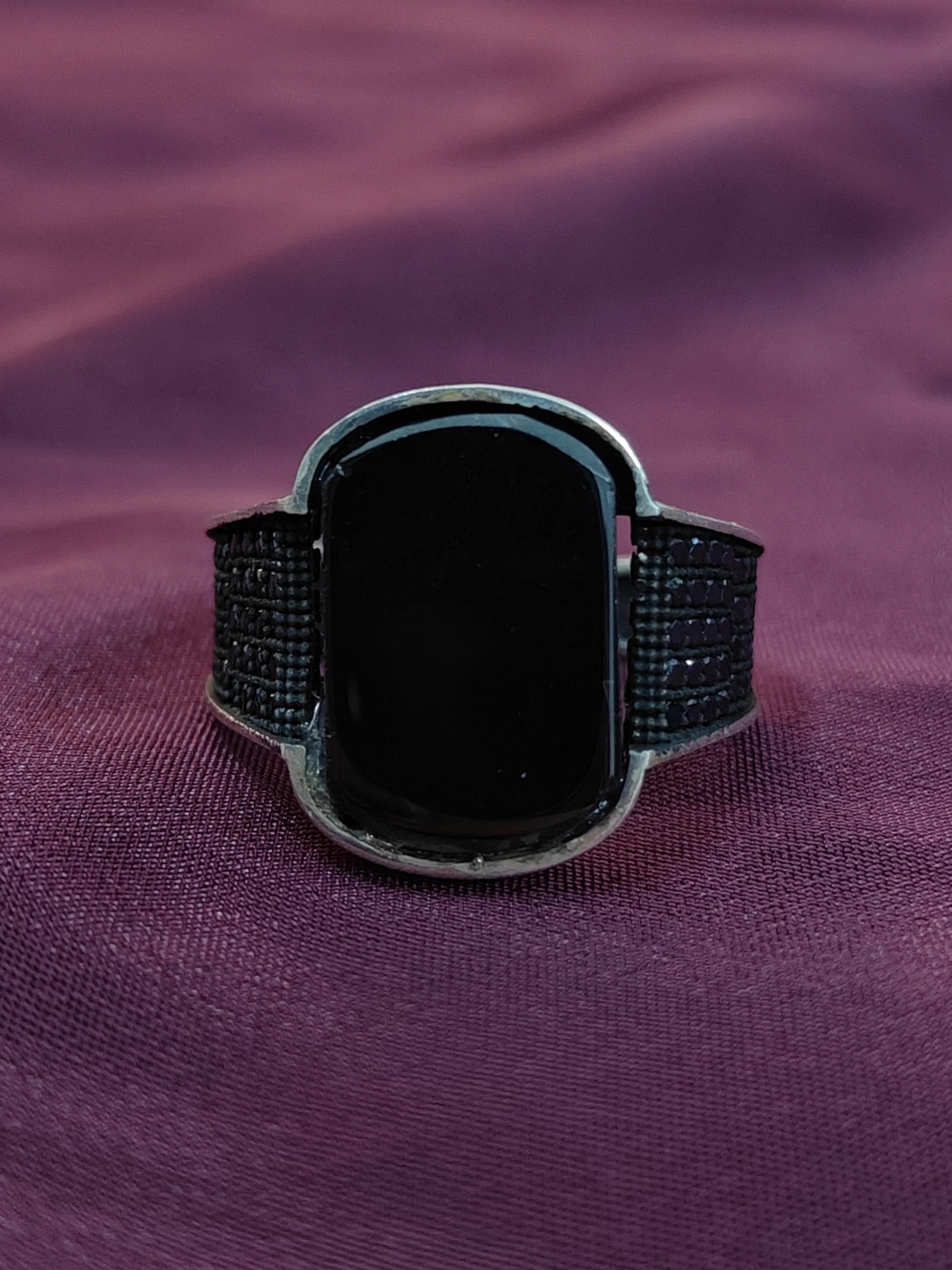 Black smartwatch on a purple fabric background