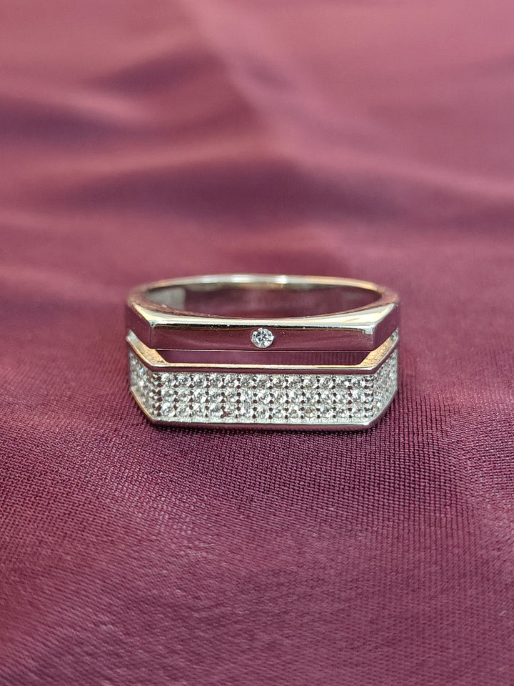 Gold and diamond ring on a maroon fabric background