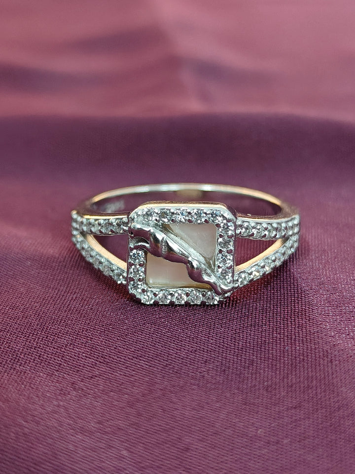Elegant ring with a central stone and diamond accents on a purple fabric background