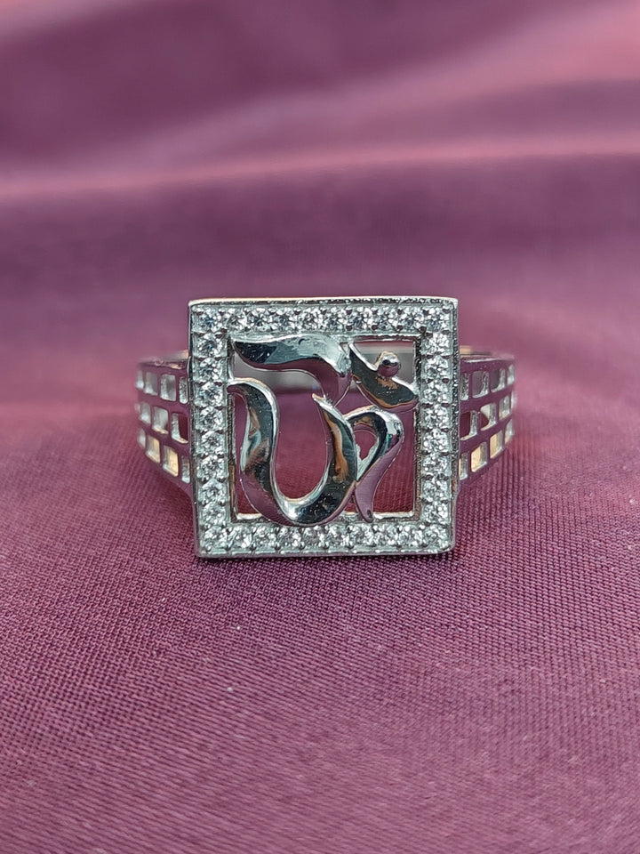 Silver ring with dolphin design on a purple fabric background