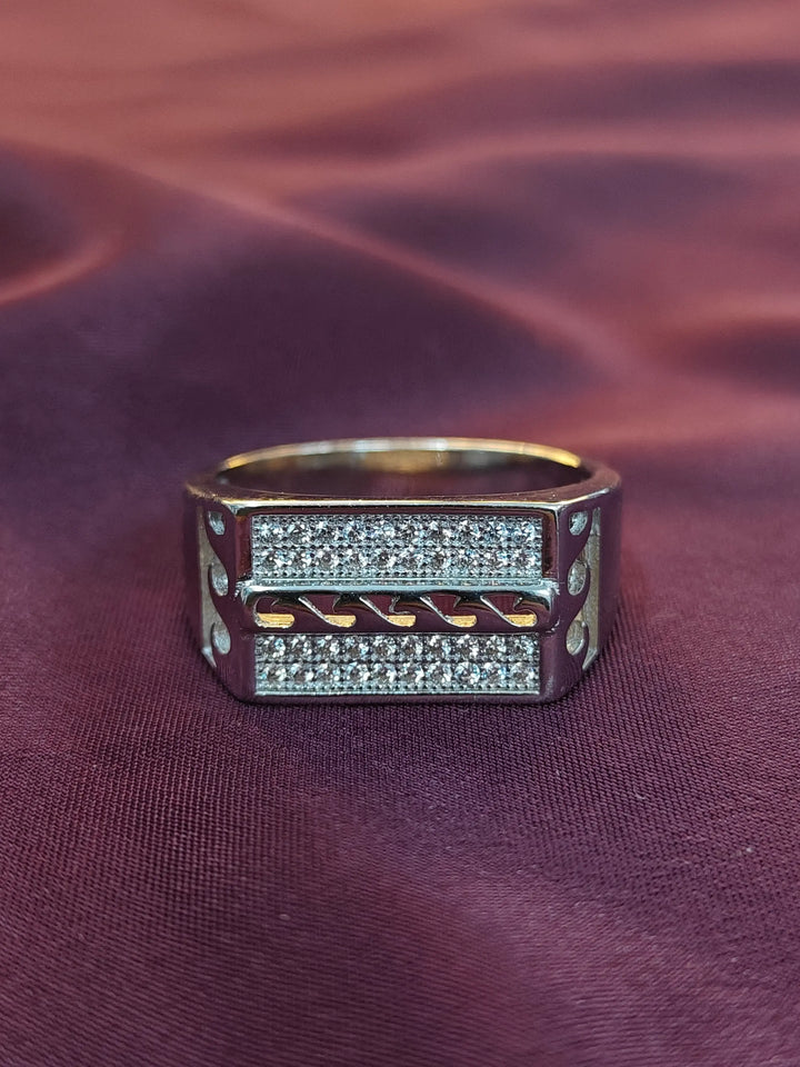 Gold and silver ring on a textured purple fabric background