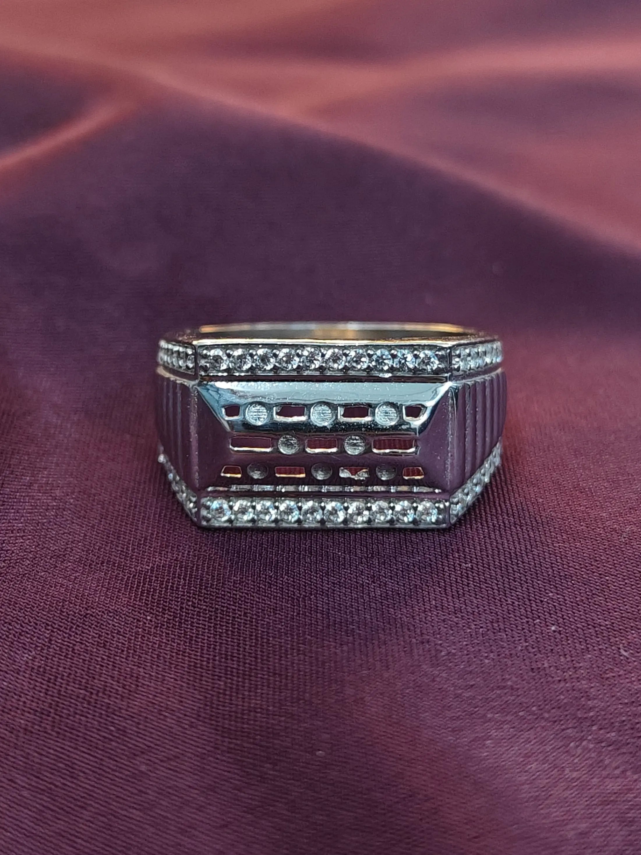 Ring with electronic components on a purple fabric background