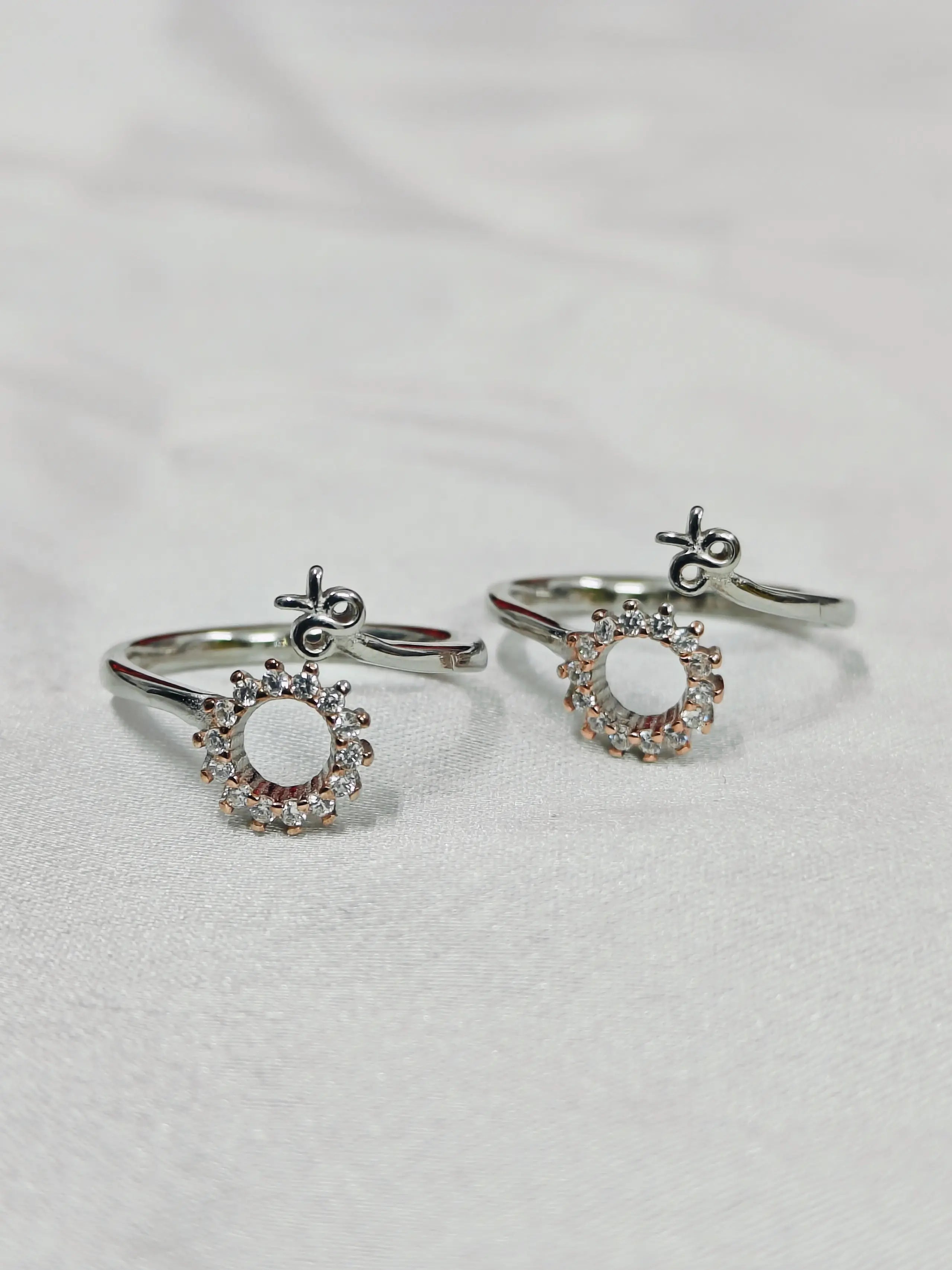 Pair of silver earrings with circular designs on a light gray background