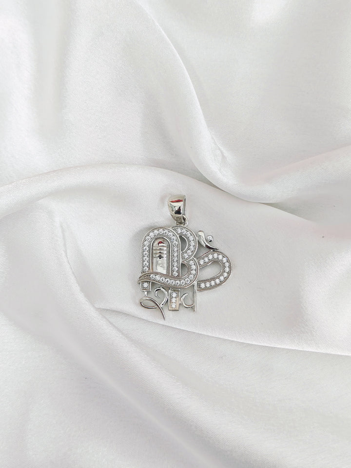 Silver pendant on a white satin background