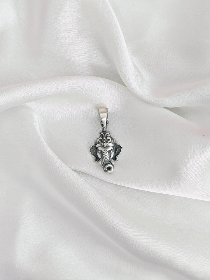 Silver pendant on a white satin fabric