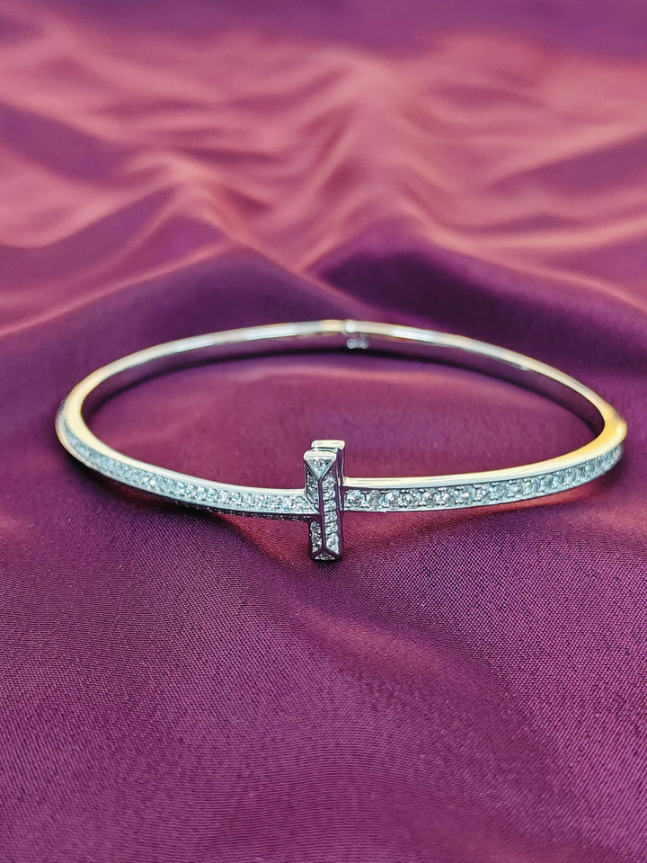 Gold and silver bracelet on a purple fabric background