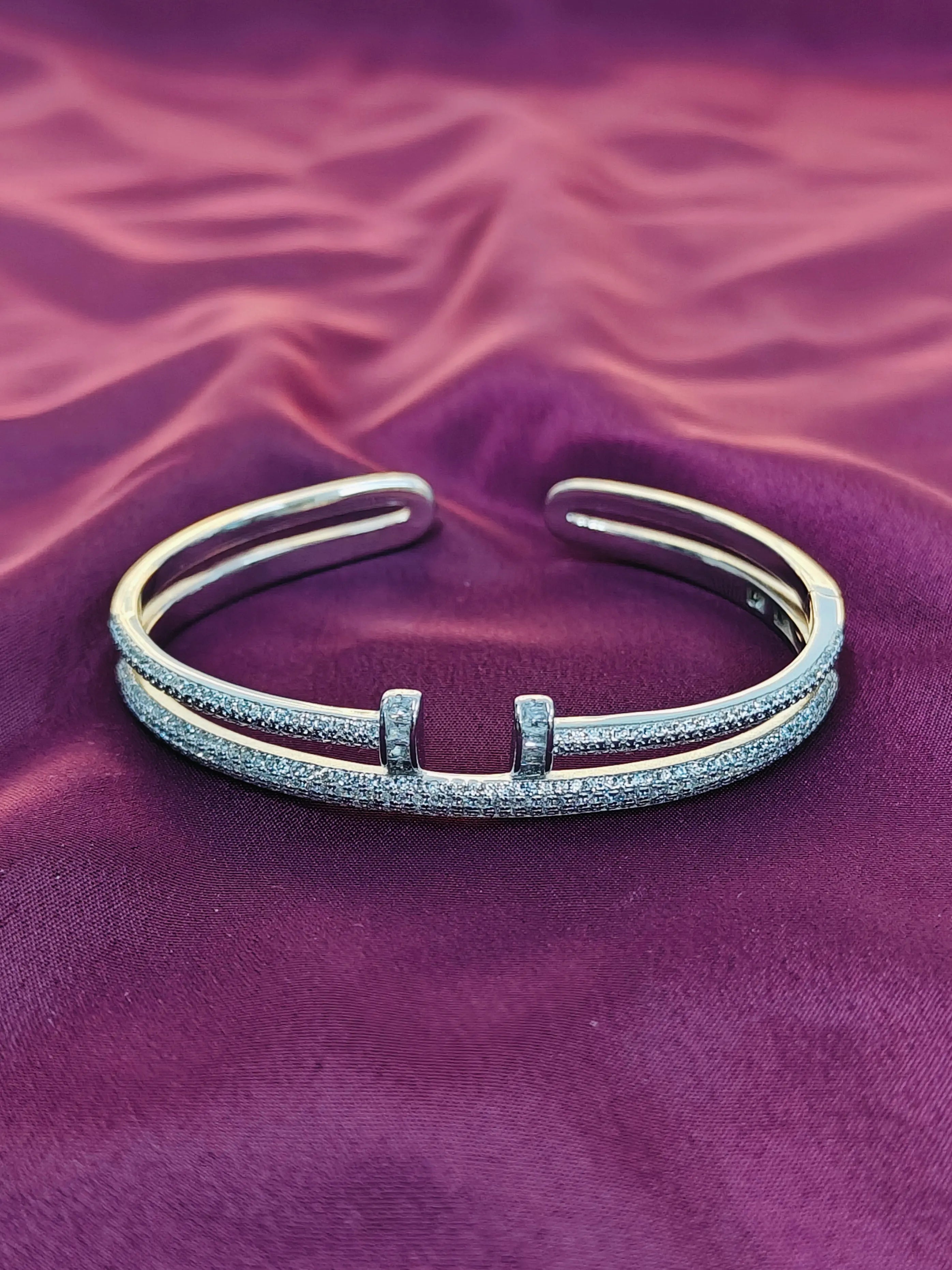 Silver bracelet on a purple fabric background