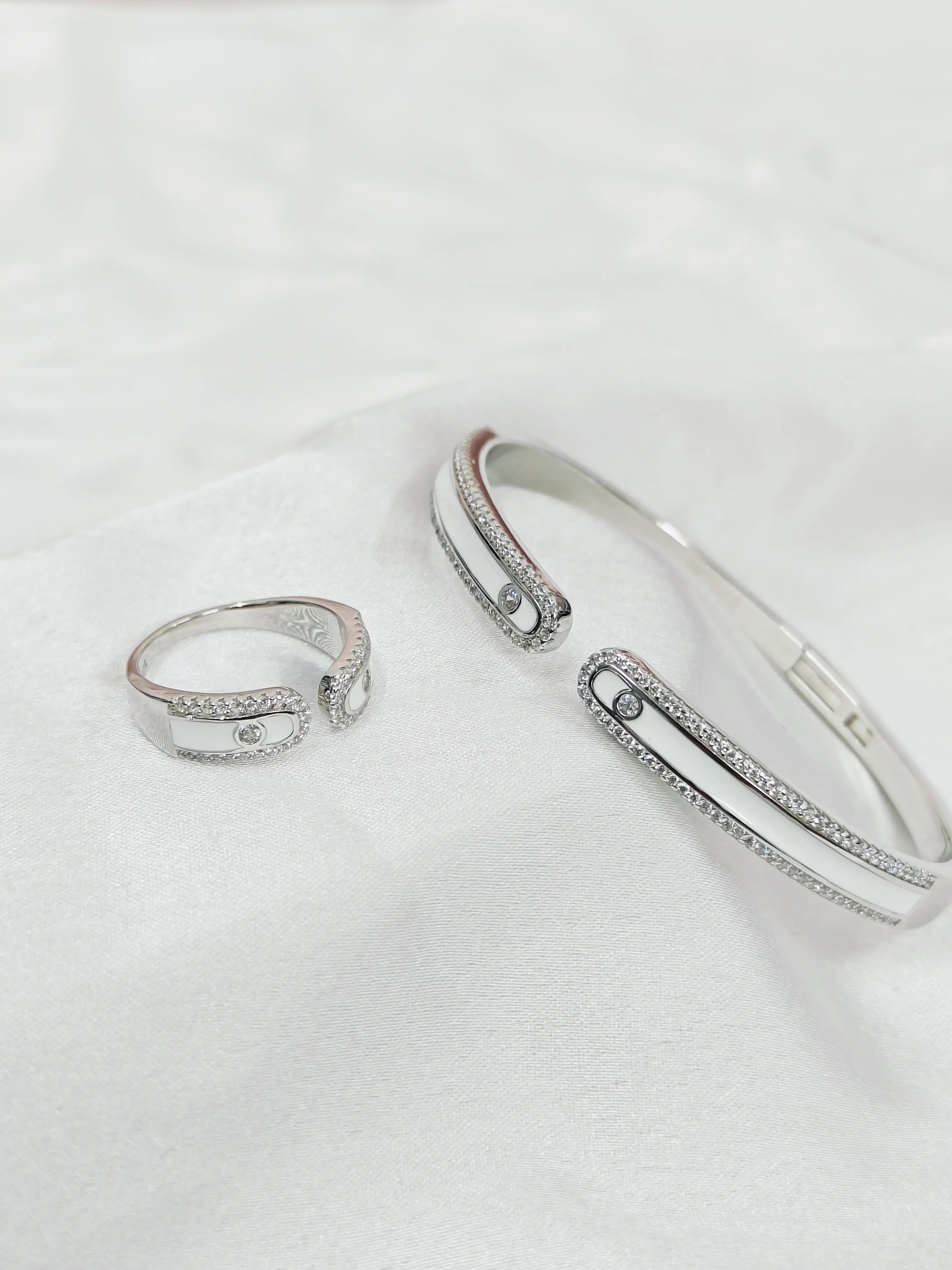 Silver ring and bracelet set on a white background