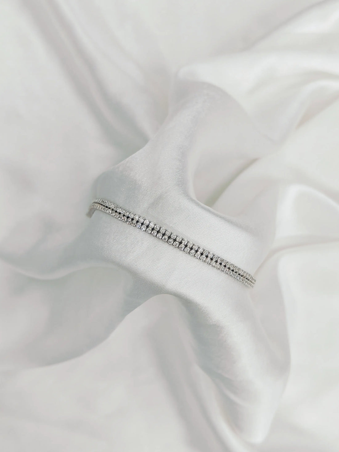 Silver zipper on a white fabric background