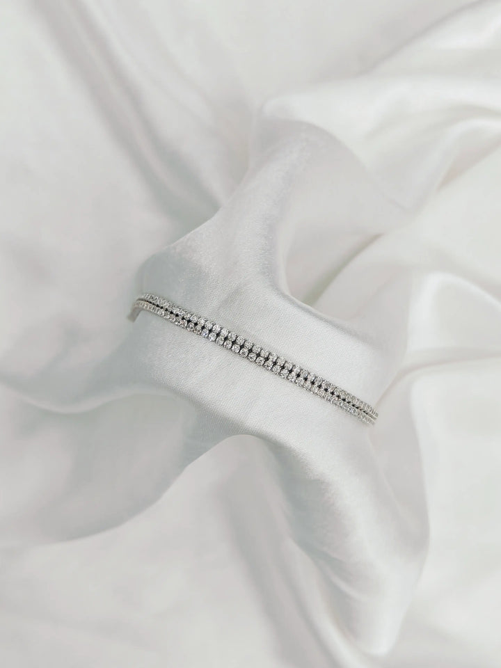 Silver zipper on a white fabric background