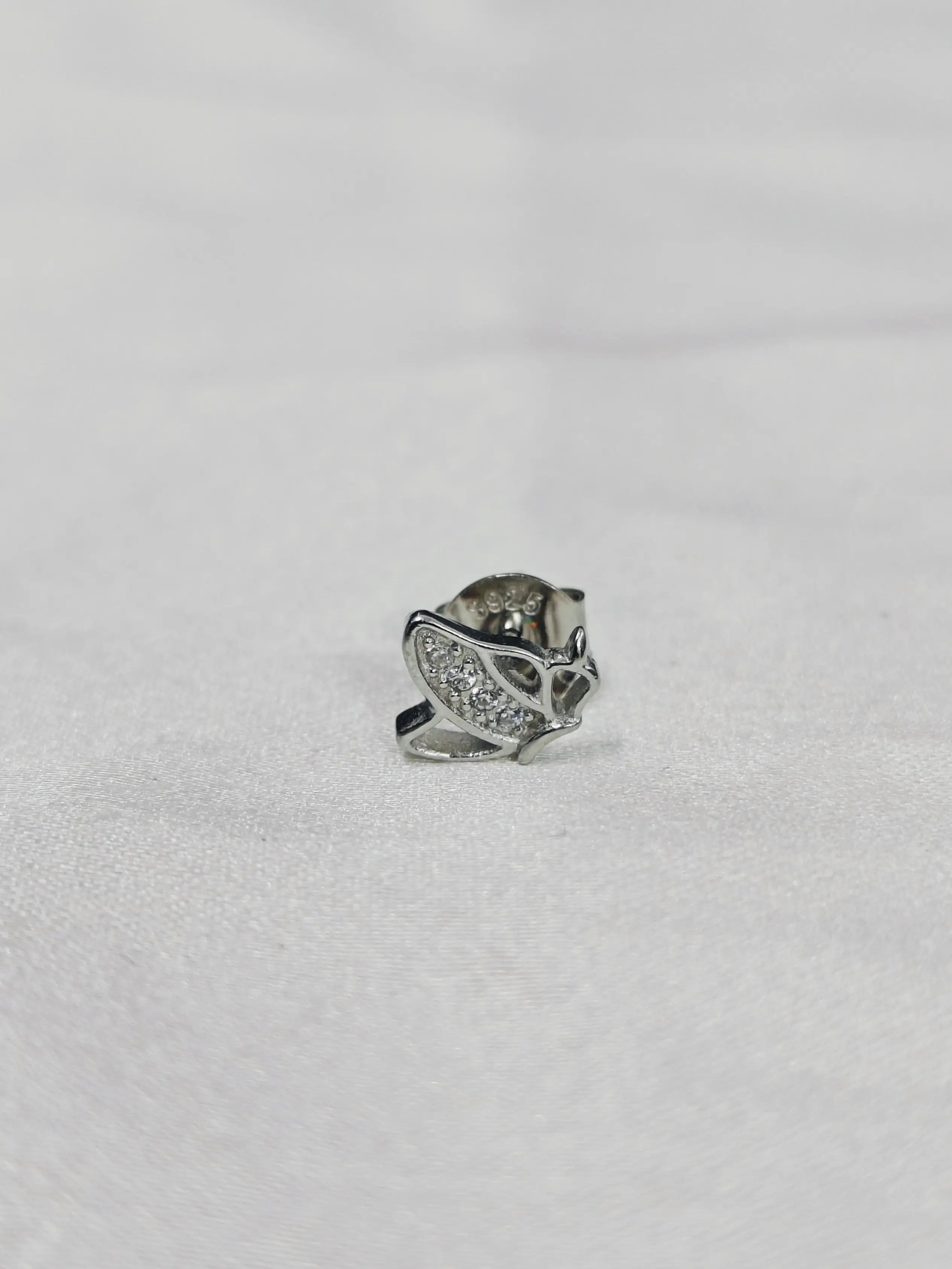 Silver ring with gemstones on a light gray background