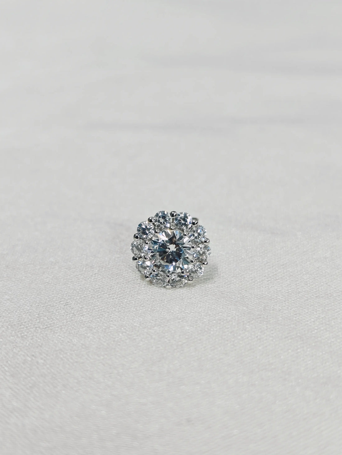 Diamond earring on a light gray background
