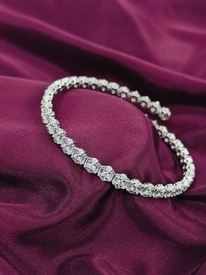 Silver necklace on a purple fabric background